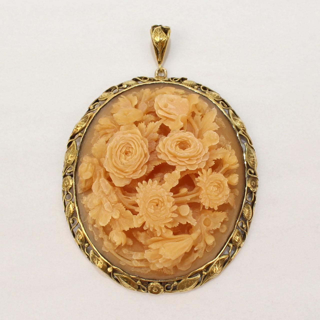 A very fine large hand relief carved horn pendant.

With a three dimensional bouquet of flowers that is bezel set in 14k gold. The setting has a leaf and flowers pattern.

We think that this is likely of Chinese origin and from the early to mid 20th