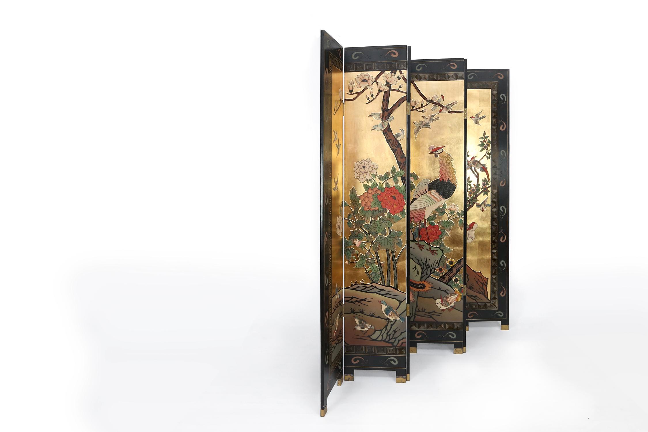 Stunning large black lacquered chinese folding screen/roomdivider with exception detailed paintings. Use as a room divider or as piece of art. The peaceful garden scenes, replete with birds, trees, flowers and leaves add a sense of tranquility to