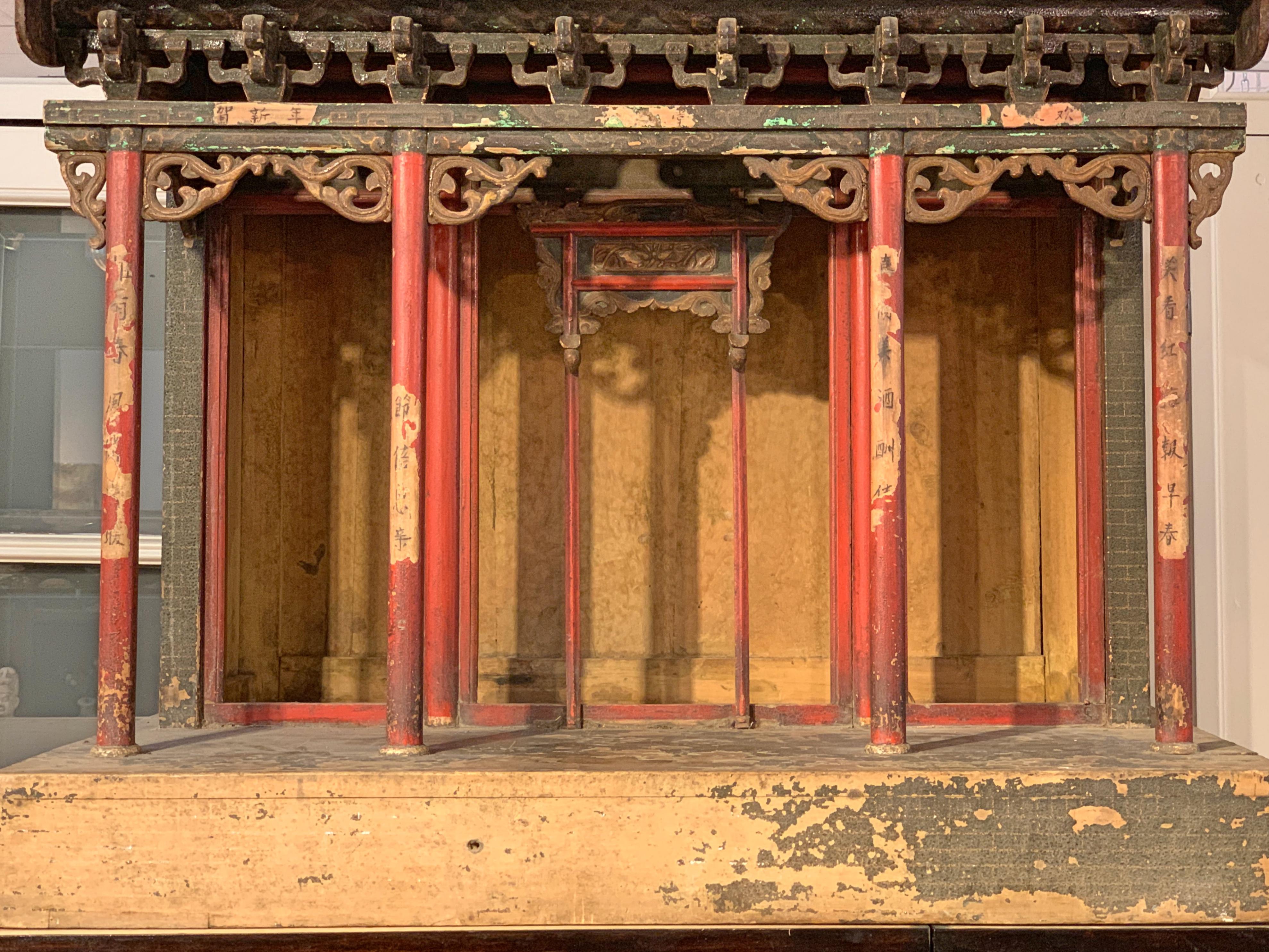 A large and fabulous Chinese carved, lacquered and painted wood architectural model of an ancestral hall, Qing Dynasty, 18th century.

The ancestral hall architectural model set on a raised foundation and featuring a stunningly detailed hip and