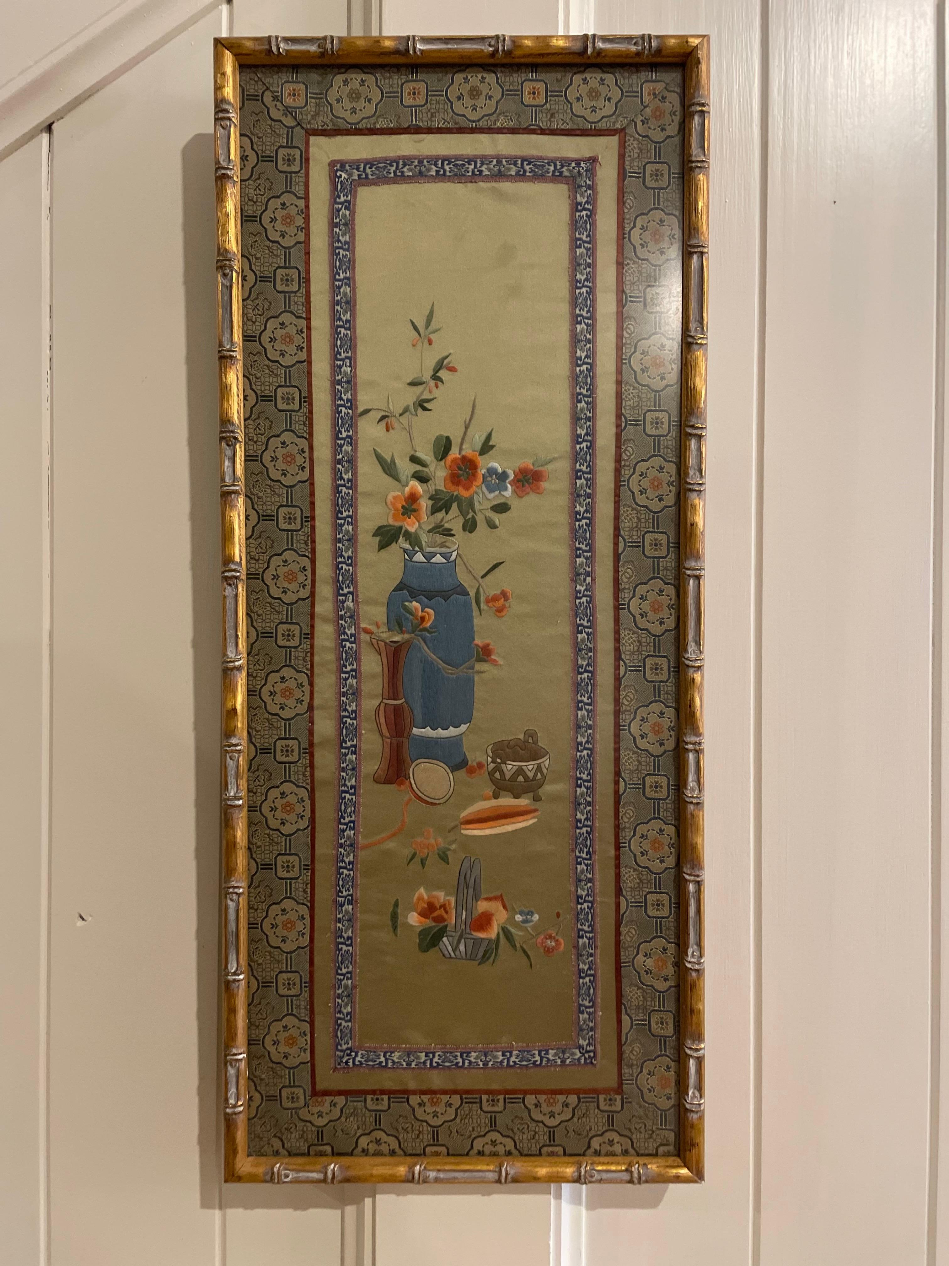 A long tall beautiful rectangular framed Chinese silk tapestry. A lovely addition to any wall. This tapestry portion of this piece is framed inside of a gold bamboo wood frame. The tapestry itself is exquisite. The center of this long silk panel is