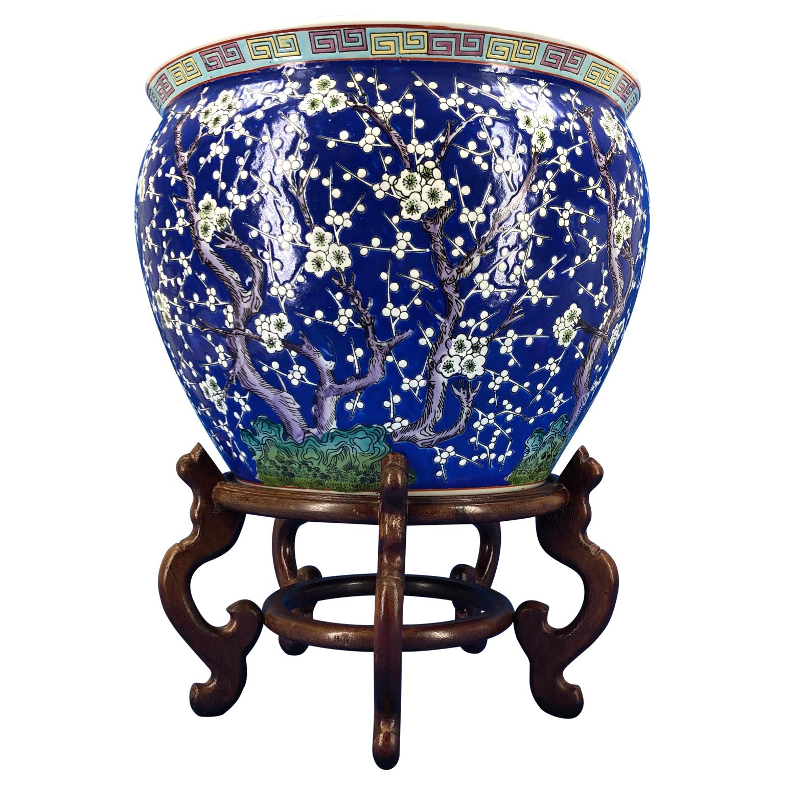 Large Chinese blue decorated porcelain jardinieres planter on wooden stand.