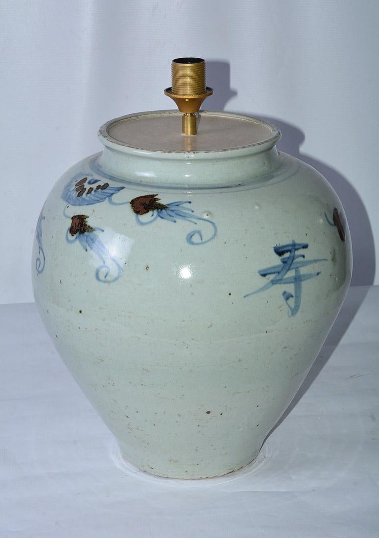 Highly decorative over-size stunning blue and white Asian style ginger jar lamp featuring a blue and white body with Chinese characters and decorative fish details. Including blue Belgium linen lamp shade.
Jar measures 15.5 D x 19.5 H
Height with