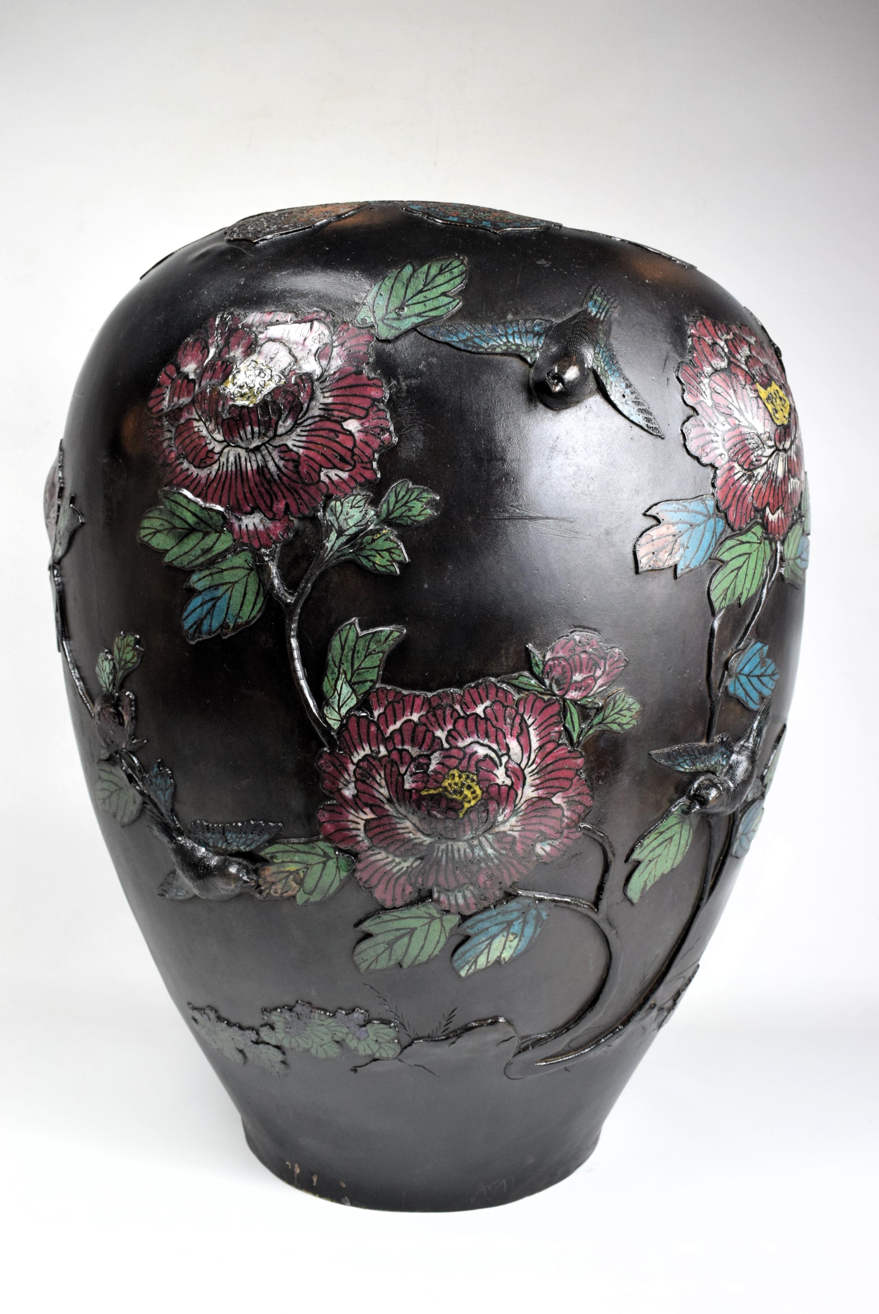Large Japanese, Bronze Relief Enameled Vase, Early 20th Century

The vase's surface is adorned with intricate relief work that depicts a stunning tableau of flowers and birds. The relief work is meticulously crafted, creating a three-dimensional