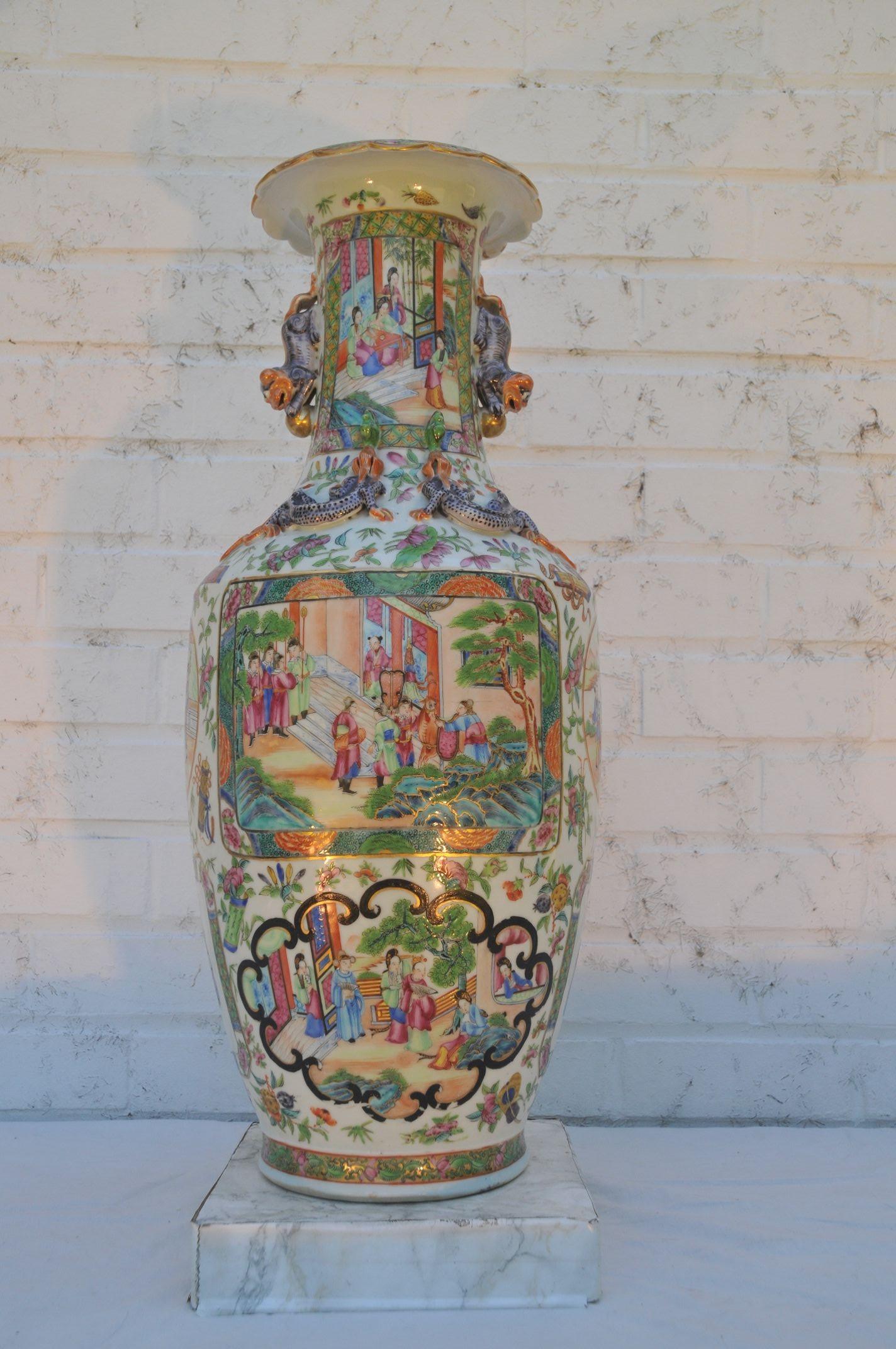 The baluster sides surmounted on a flower-shaped everted rim, painted overall in vivid enamels and gilt with shaped panels enclosing scenes with dignitaries in a flowering garden, all reserved on a gilt ground enriched with an abundance of pink