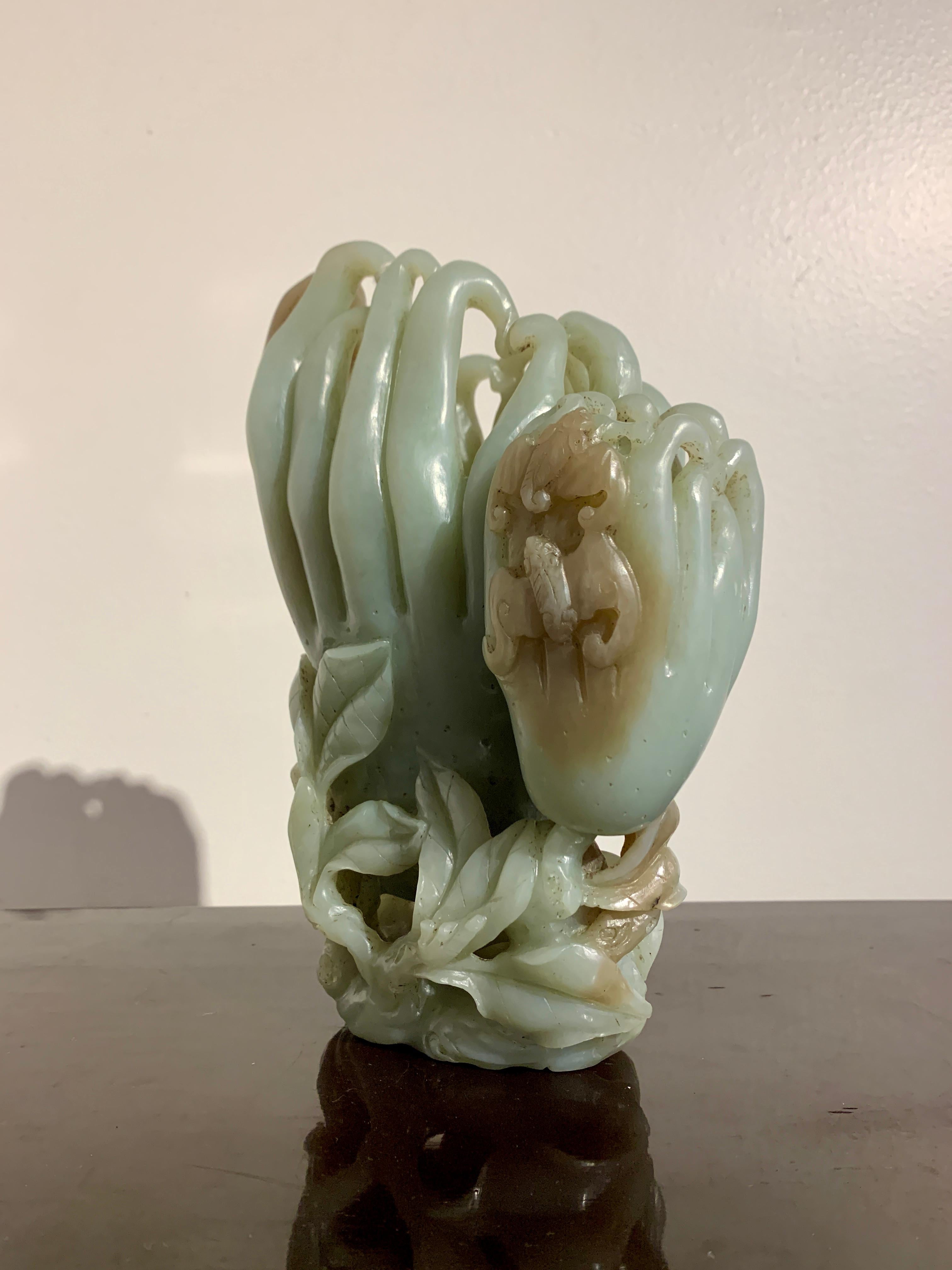 A large and graceful carved nephrite jade conjoined double vase in the form of a pair of Buddha's hands fruit (finger citron), late Qing Dynasty, circa 1900, China.

The large and heavy vase carved from a single piece of celadon nephrite jade,