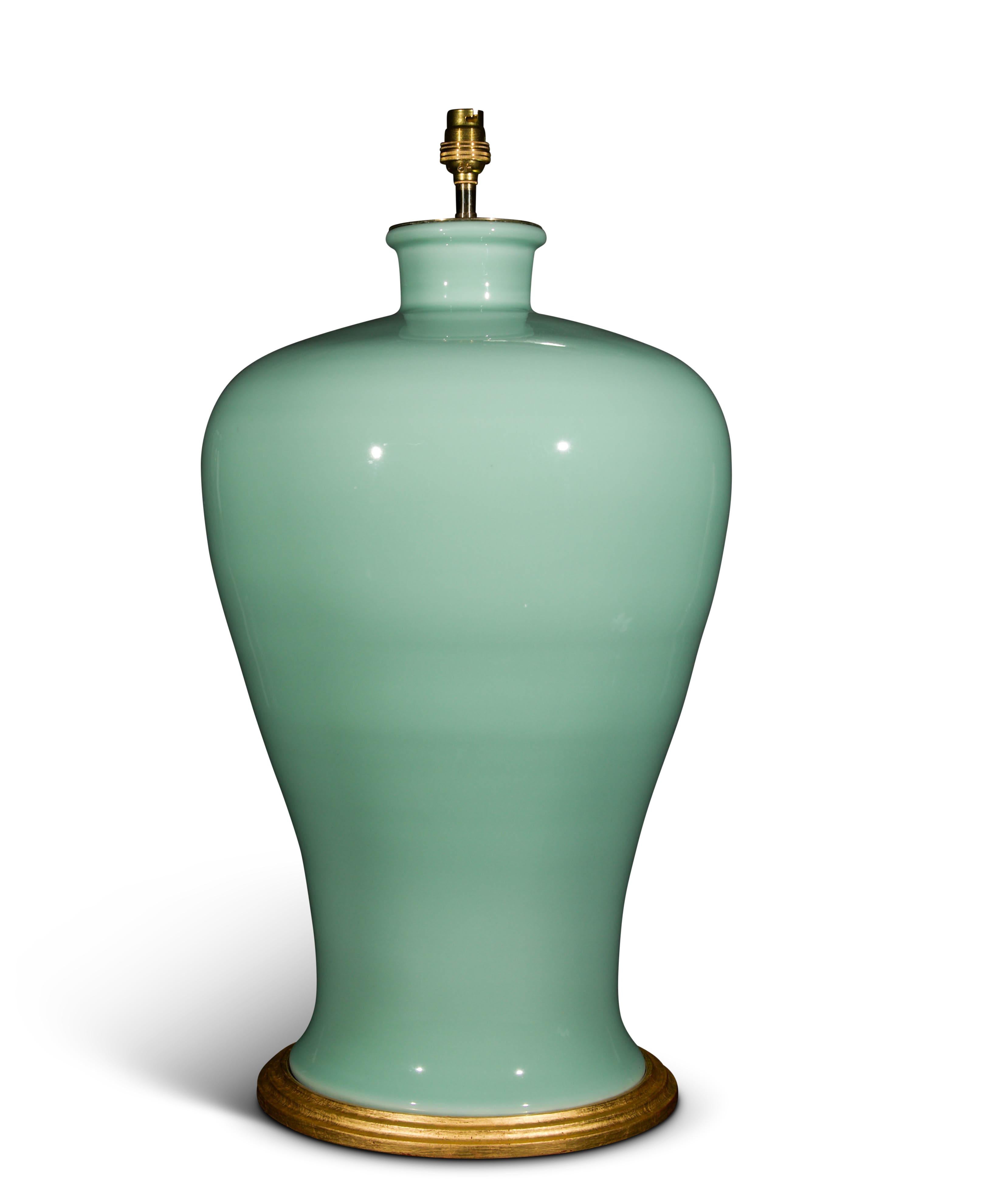 A fine large Chinese porcelain celadon glazed baluster vase, now mounted as a lamp with hand gilded turned base.

height of vase: 21 1/4 in (54 cm) including giltwood base, excluding electrical fitment and lampshade.

All of our vases can be