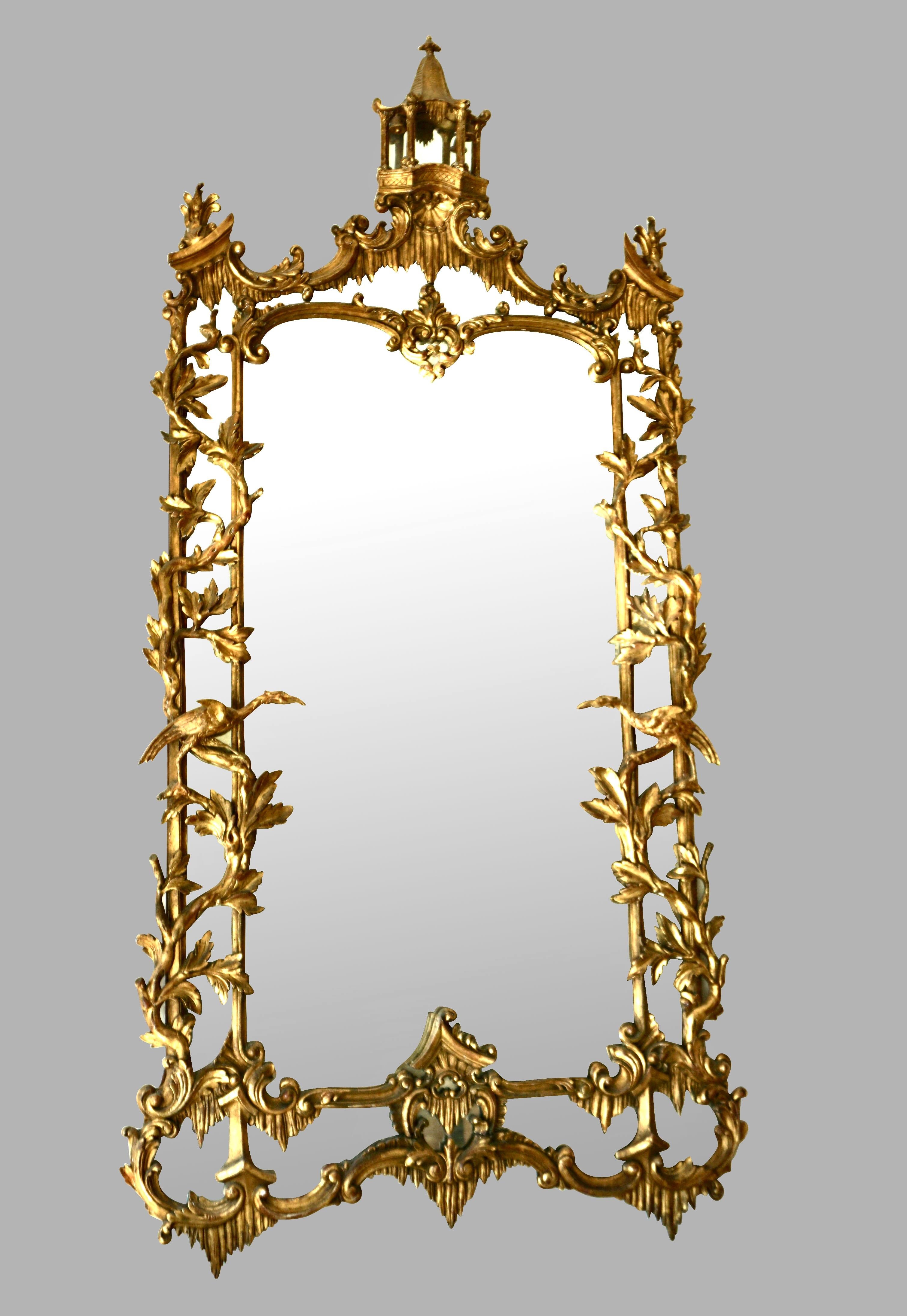 This is a lovely large Chinese Chippendale mirror of excellent quality. The central mirror plate is topped by a charming carved pagoda, the perimeter is decorated with leaves and branches with perched well-carved ho-ho birds on each side. The main
