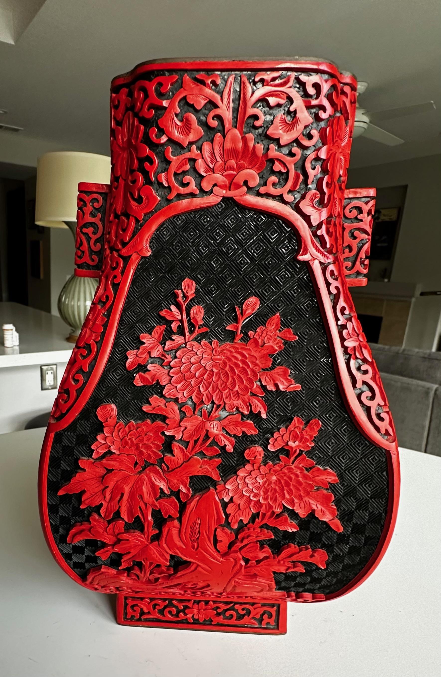 Large well crafted Chinese cinnabar lacquered vase with handles and brass lining.