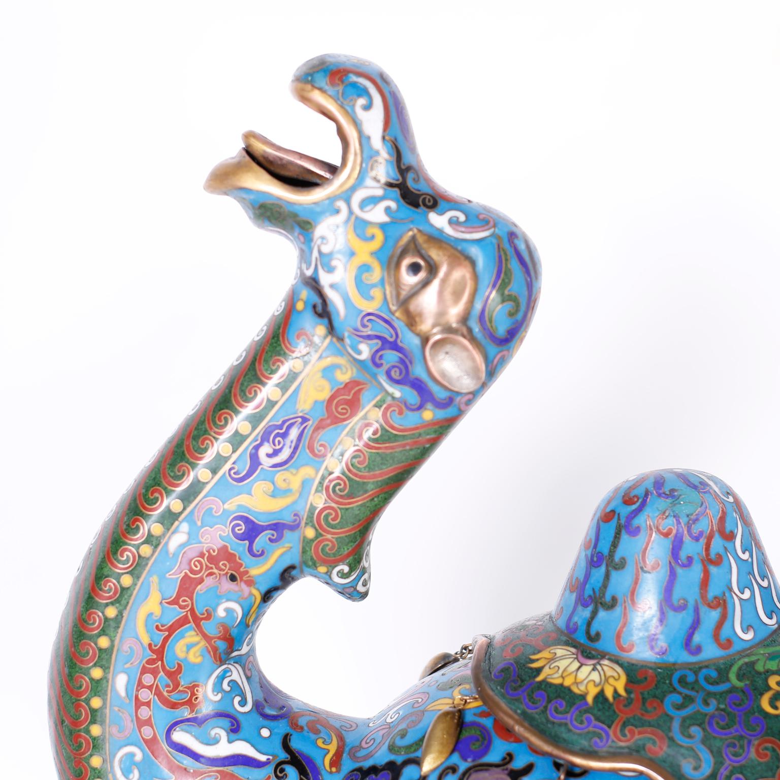 Vintage large Chinese Cloisonne lidded camel created with enamel on brass decorated in elaborate floral symbolic designs over an alluring blue background and featuring a two hump removable lid.