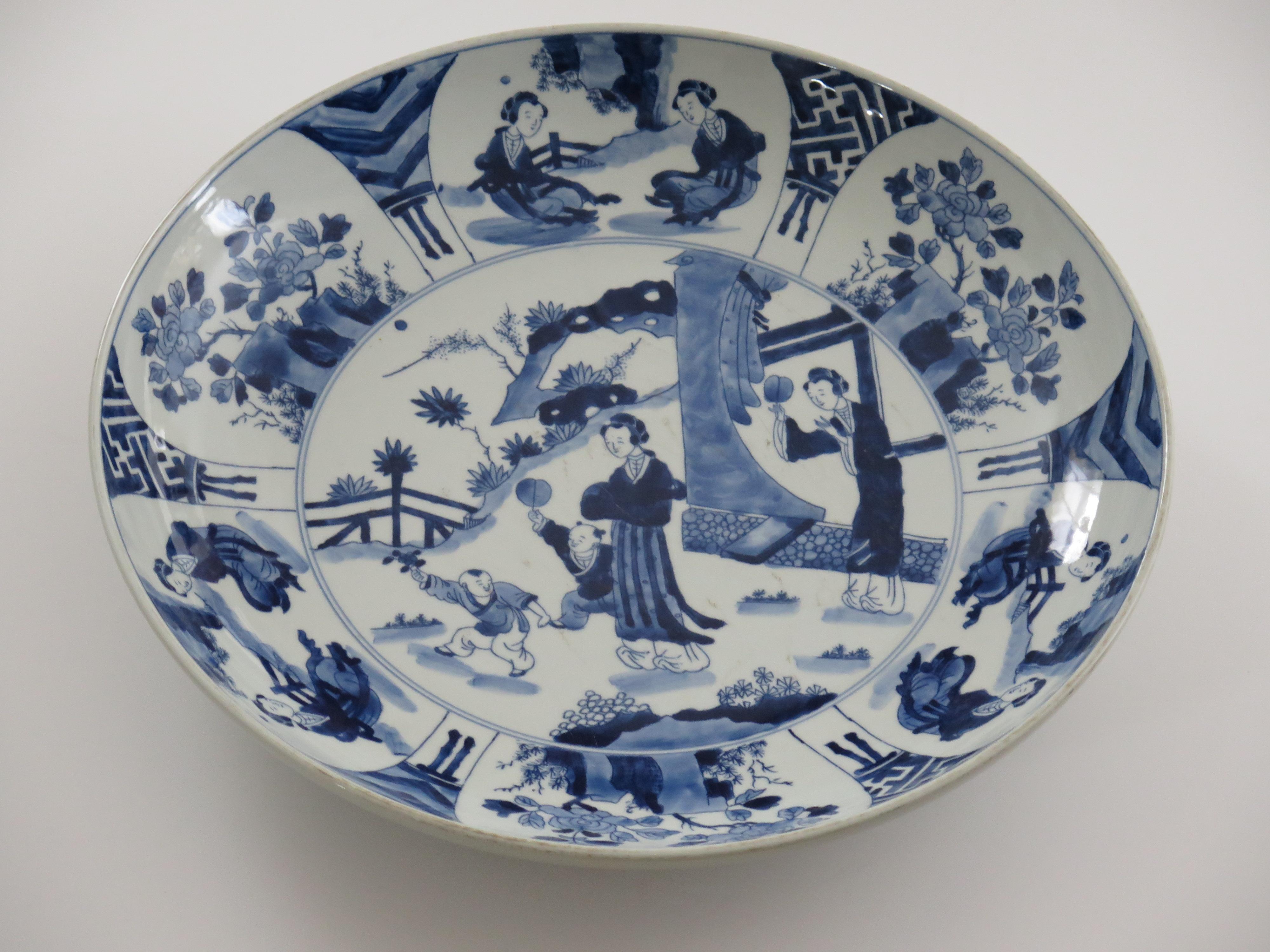 This is a very beautifully hand painted Chinese porcelain blue and white large Dish or Plate, marked to the base with the Qing, Kangxi mark( 1662-1722) but dating to the Kangxi revival period, Circa 1920's.

This is a very substantial piece of blue