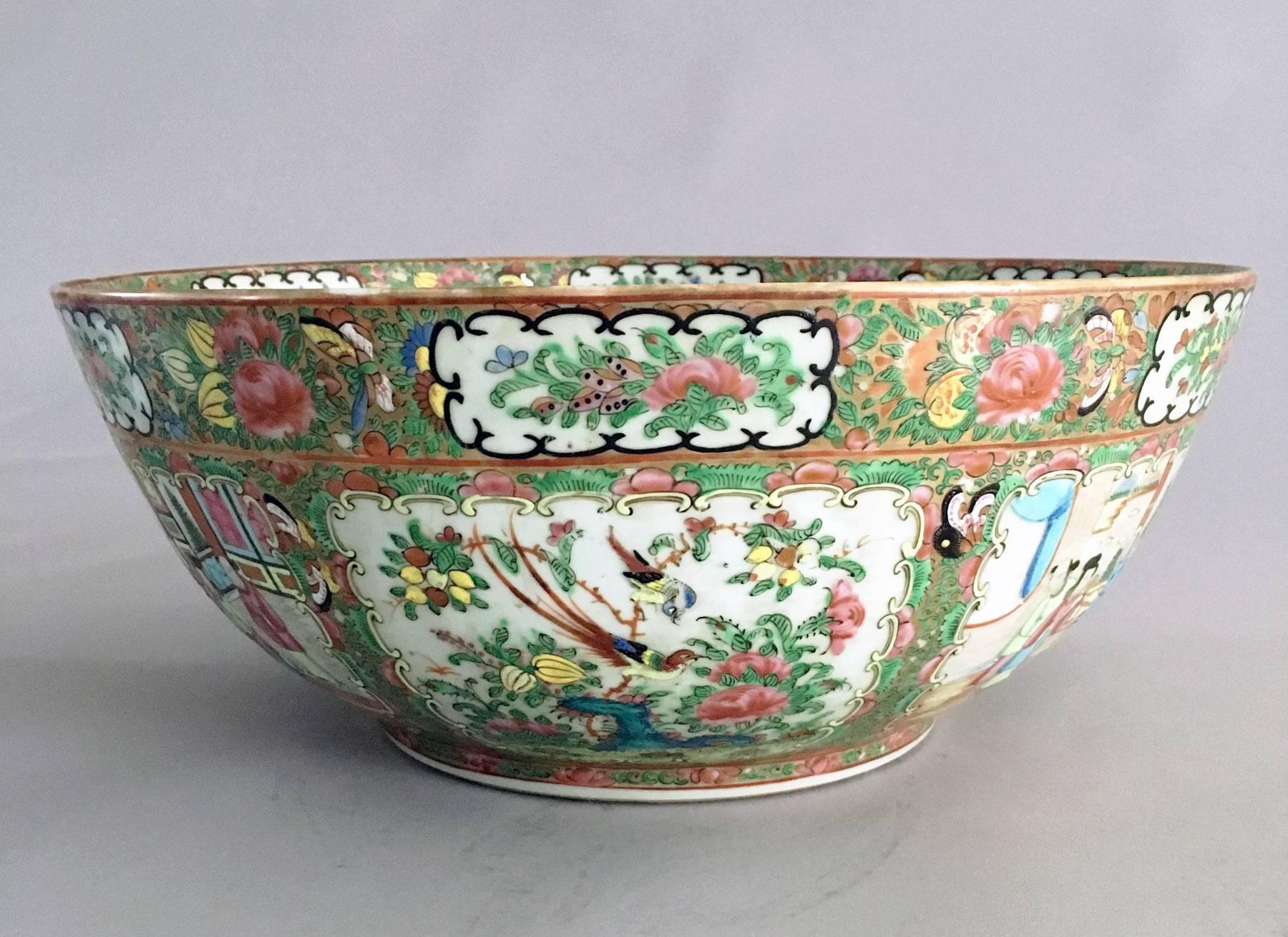 Chinese porcelain rose medallion large punch bowl decorated with six alternating panels inside and outside of court scenes of figures; birds and flowers. The very center medallion is of a rose and a bird surrounded by four panels. The usual colors