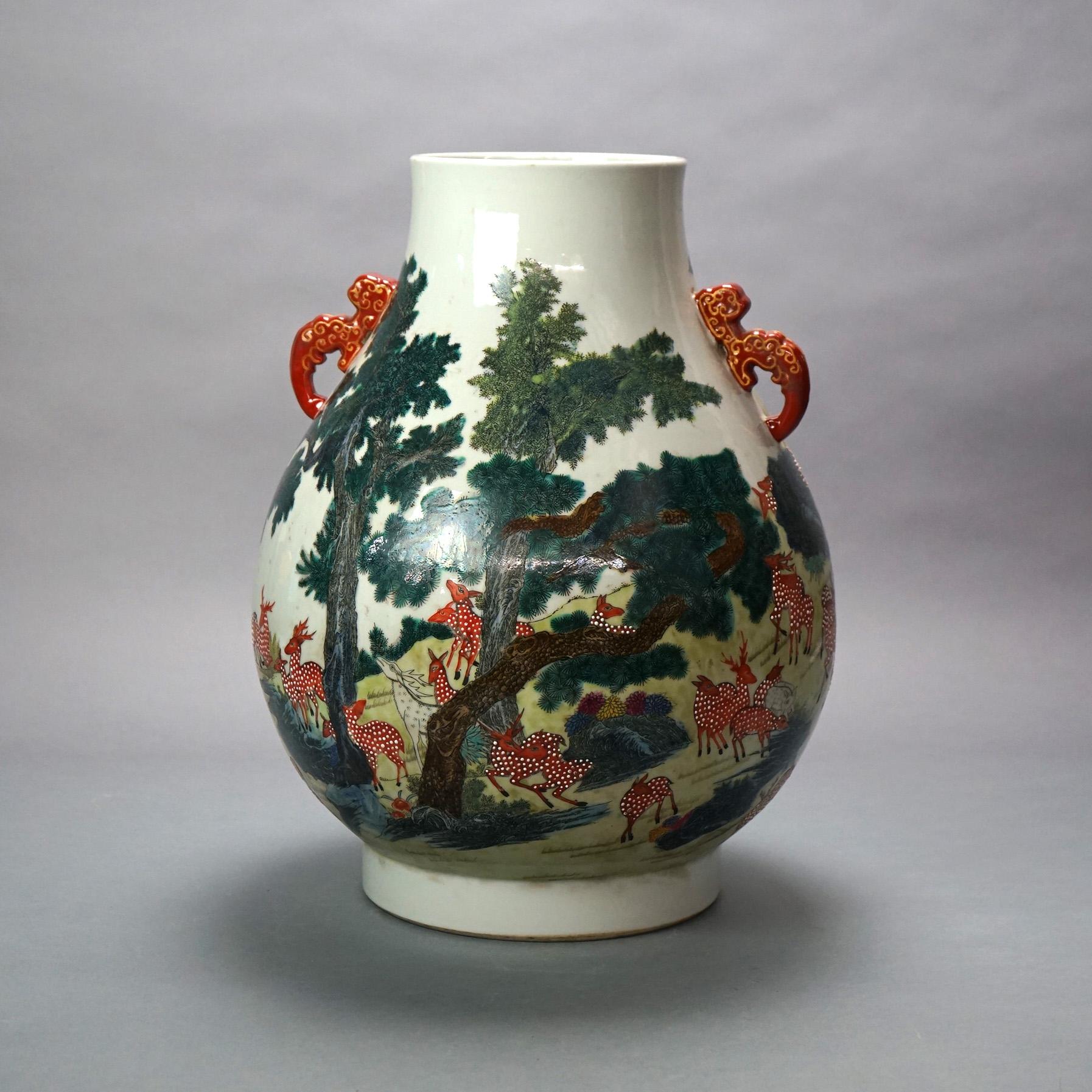 Large Chinese Famille Rose Hu Figural Landscape Porcelain Vase with Figures, Animals, Double Dragon Handles & Qianlong Mark 20thC

Measures- 18.5''H x 14''W x 14''D