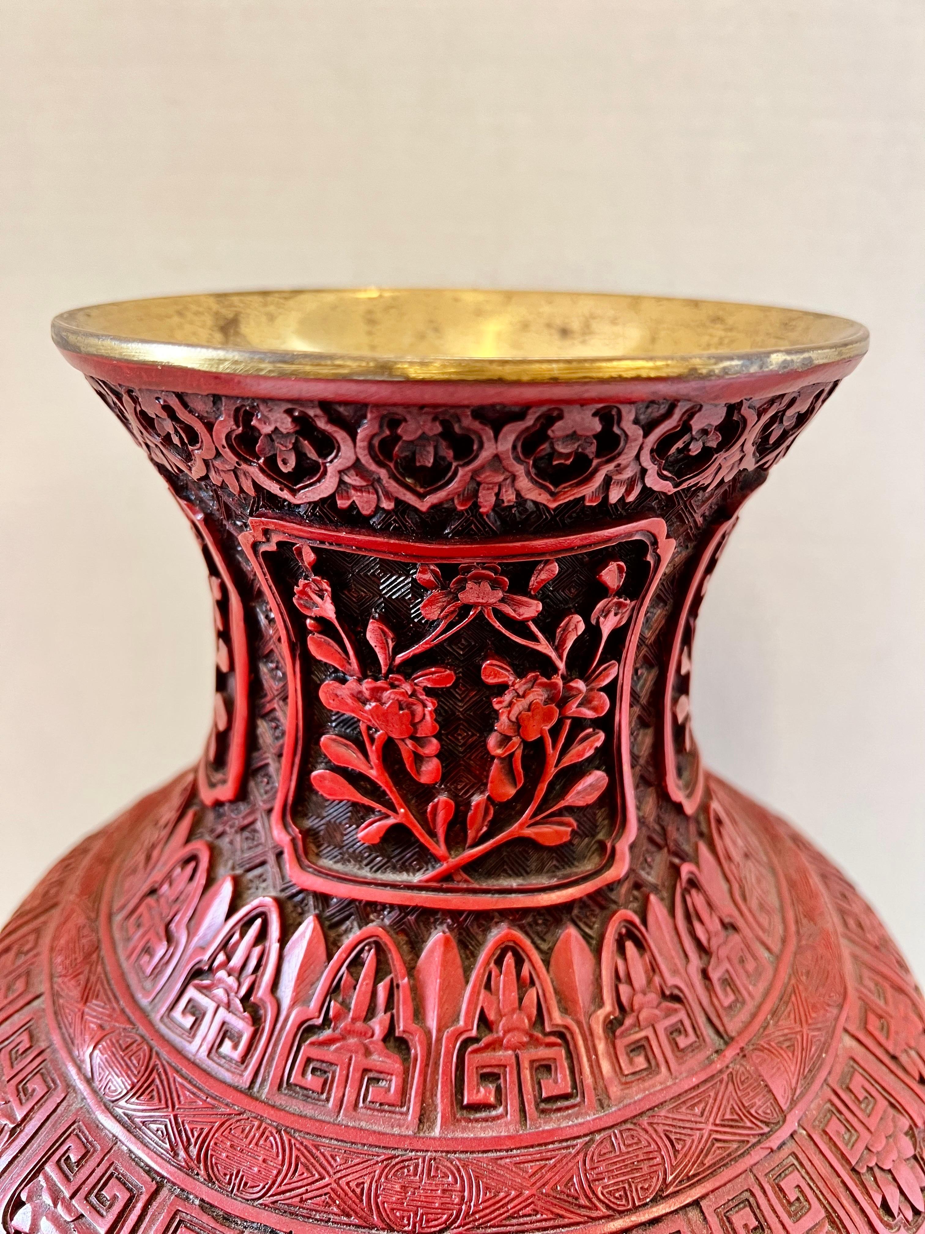 Stunning large 19”h Chinese cinnabar vase is intricately hand carved with four village scenes around the exterior. Interior is brass lined.