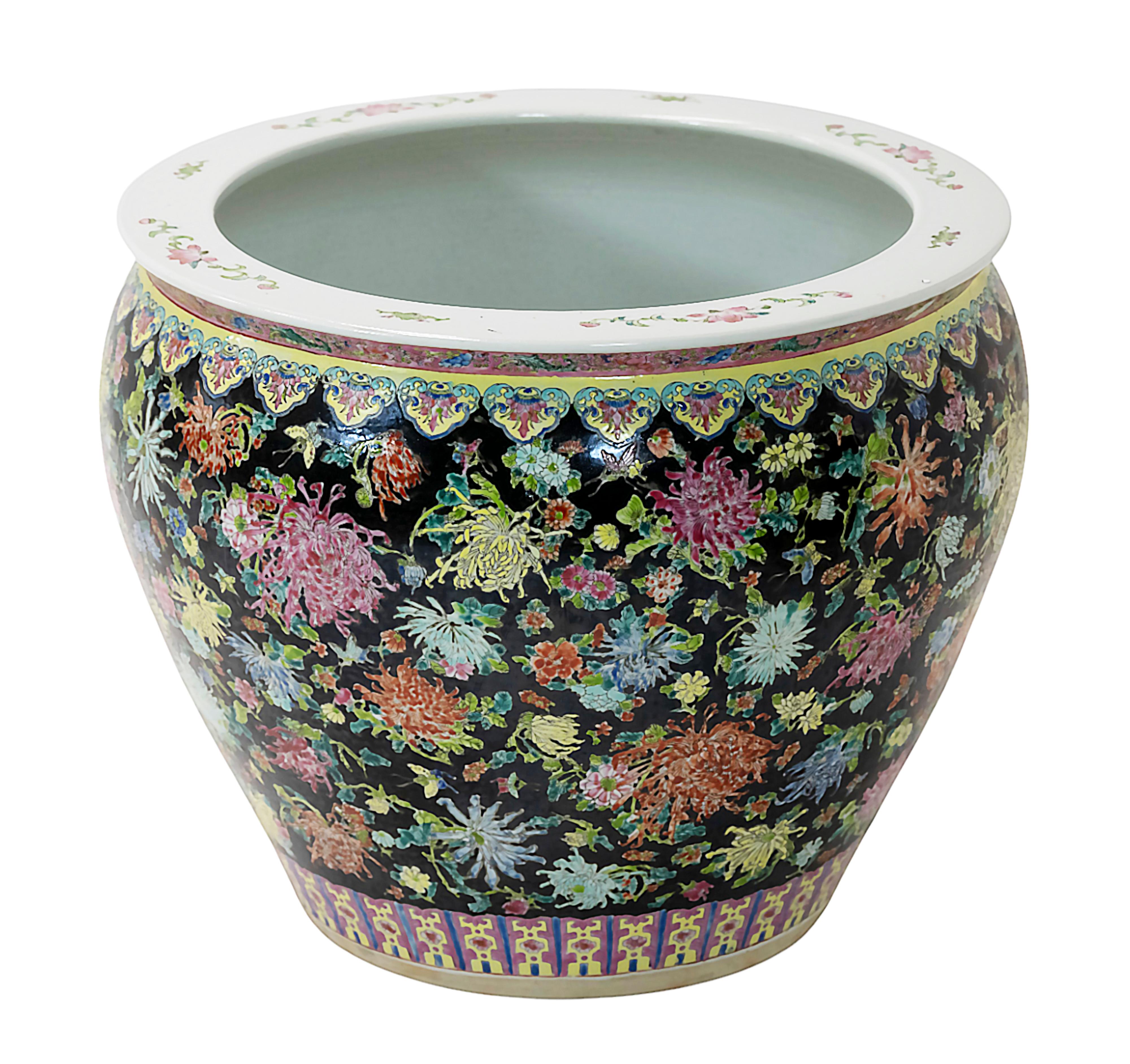 Large Chinese ceramic planter pot fish basin from late 20th century.
Outside is hand painted with multicolor floral ornaments on black background. The inside is decorated with aquatic plants and fish.
Very good vintage condition.
 