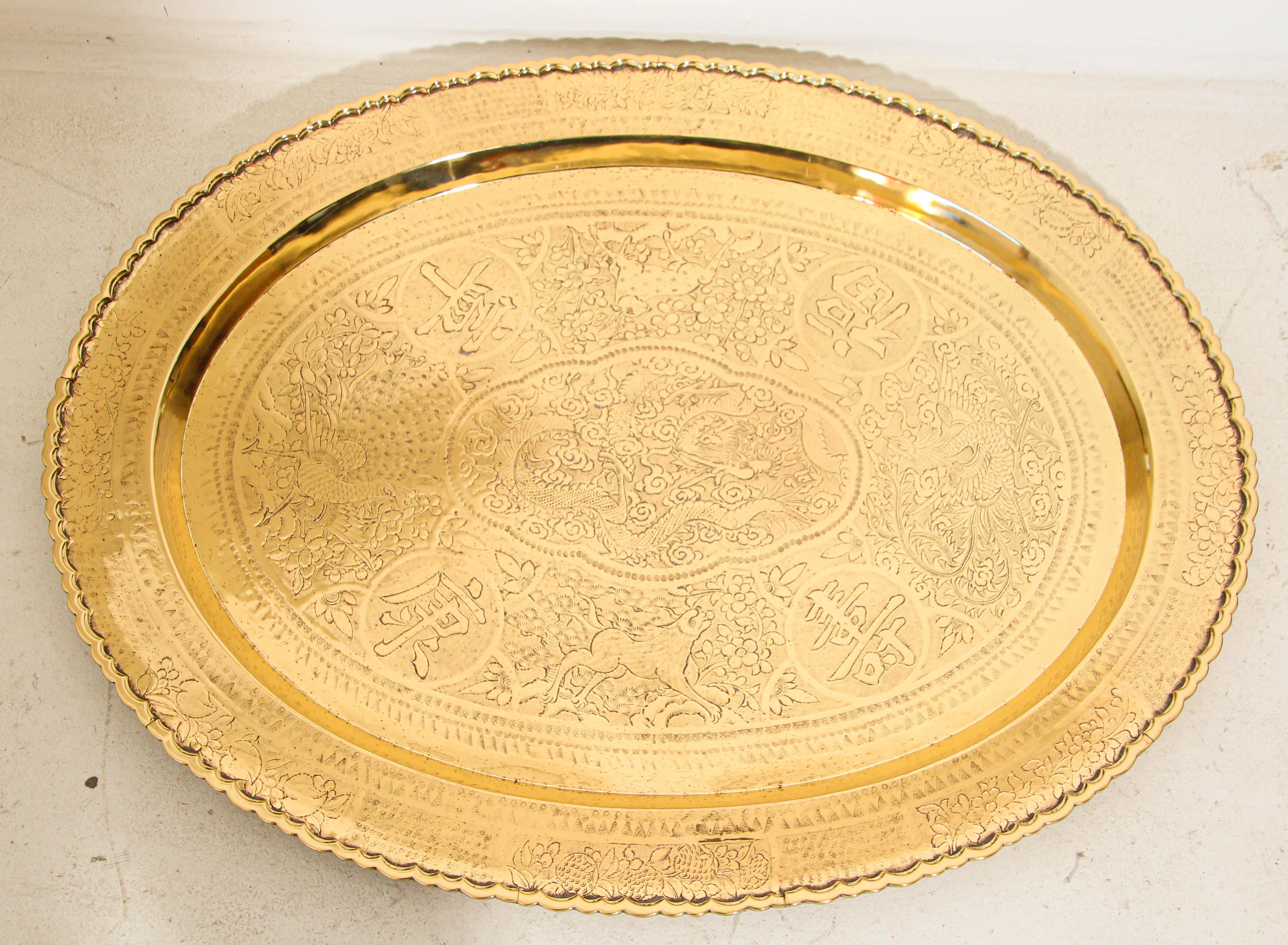 Asian Chinese imports oval metal brass tray, hammered and chiseled, engraved with dragons and different scenes of wild animals, ancient pagodas homes and foliage there are also Chinese calligraphy writing all around.
Handmade in Hong Kong ,large