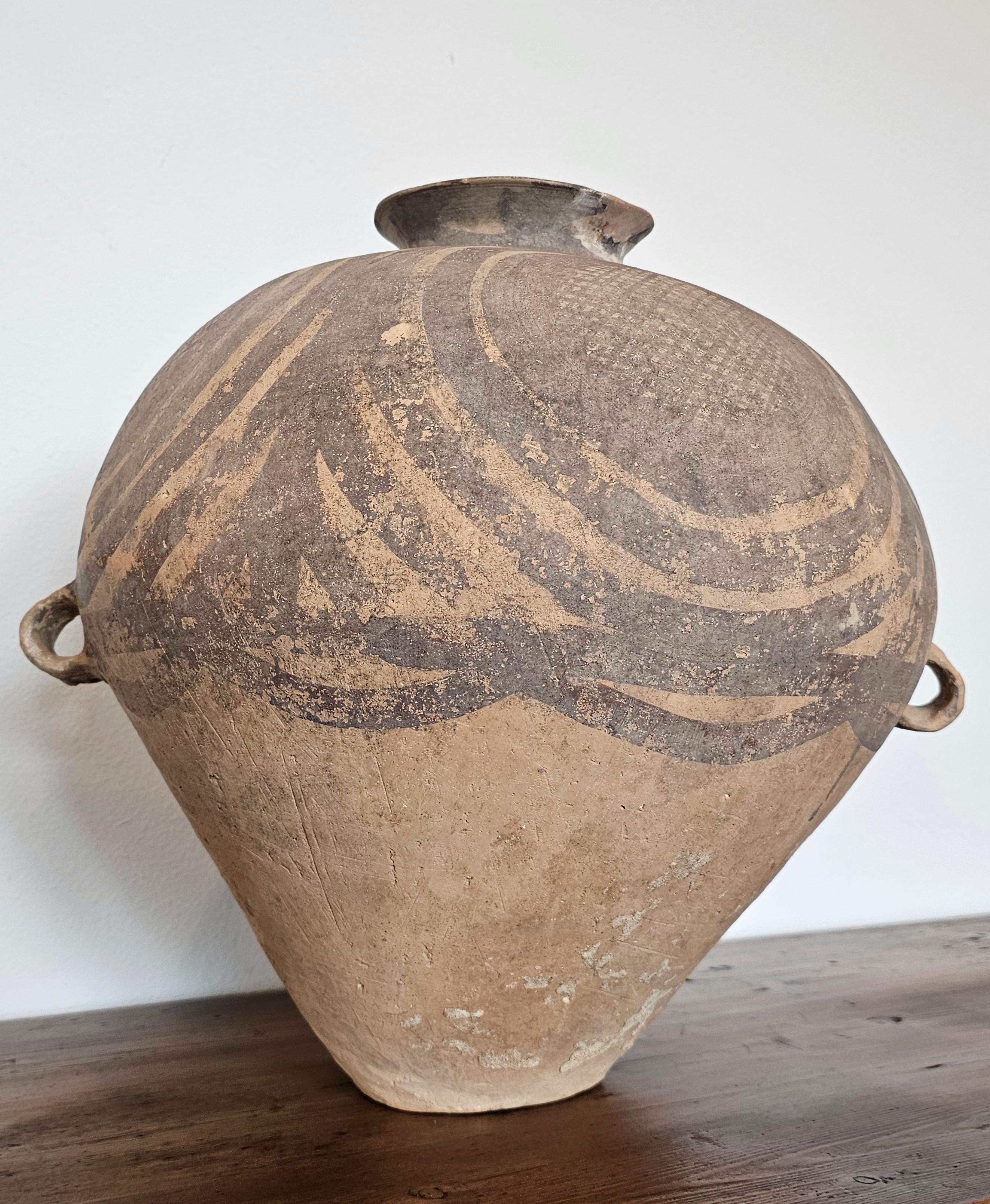 A rare Chinese Neolithic period Majiayao culture / possibly late Yangshao culture, Banshan type, Gansu Province, Northern China, 3rd-2nd Millennium B.C., large earthenware water jar (hu)

Having a globular upper body with flared mouth and loop