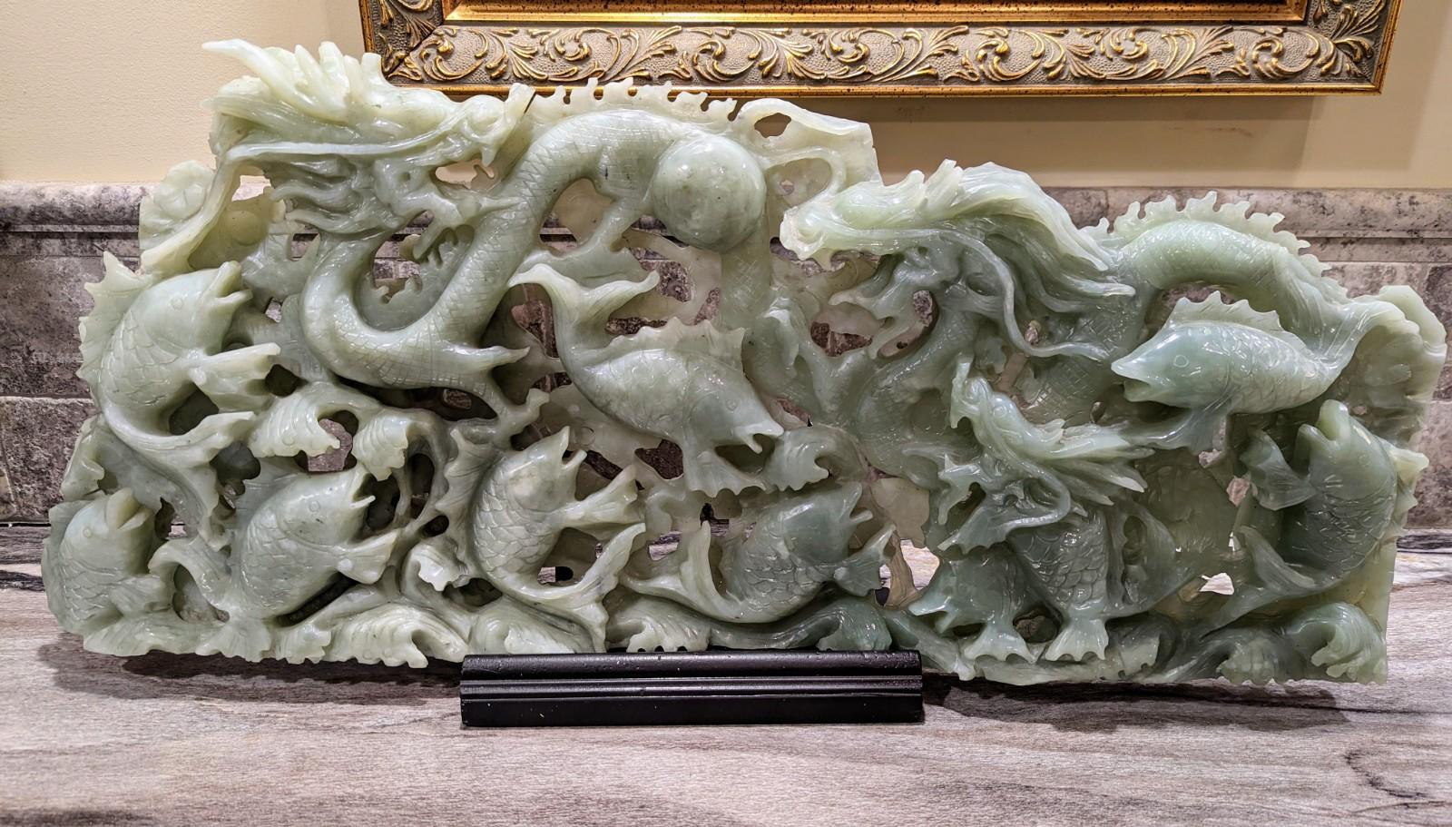Stunning large Chinese hand carved genuine jade sculpture (tested as nephrite jade) depicting dragons and koi fish. The original owner provided details that this sculpture was created during the Qing Dynasty. We were also told that the dragons