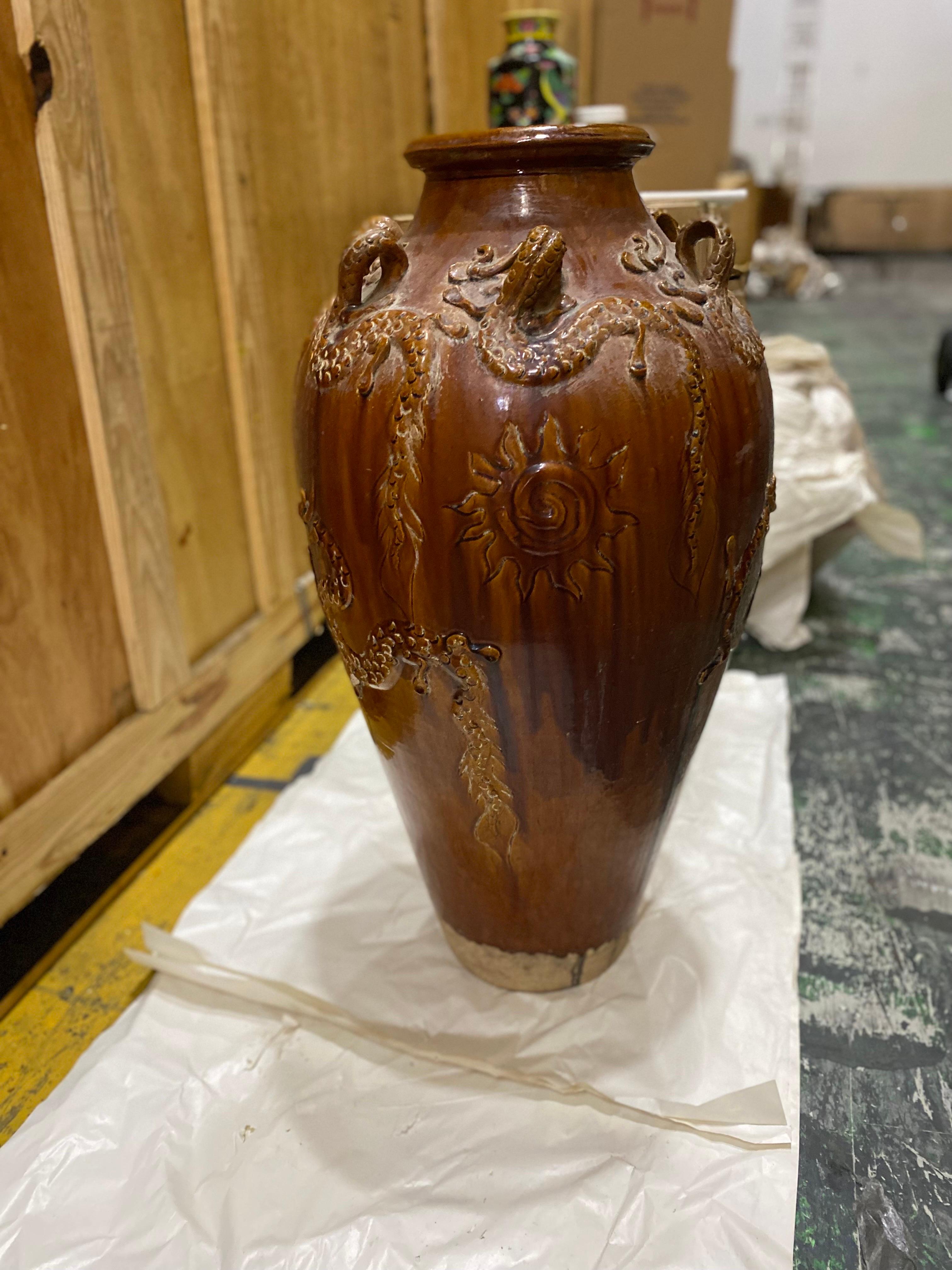 A Large Chinese Ochre brown glazed martaban jar with dragon motifs.
A beautiful large dark brown ochre glazed jar with broad shoulders and a thick-lipped narrow mouth. The glaze has a “poured effect” that results in the natural clay at the bottom
