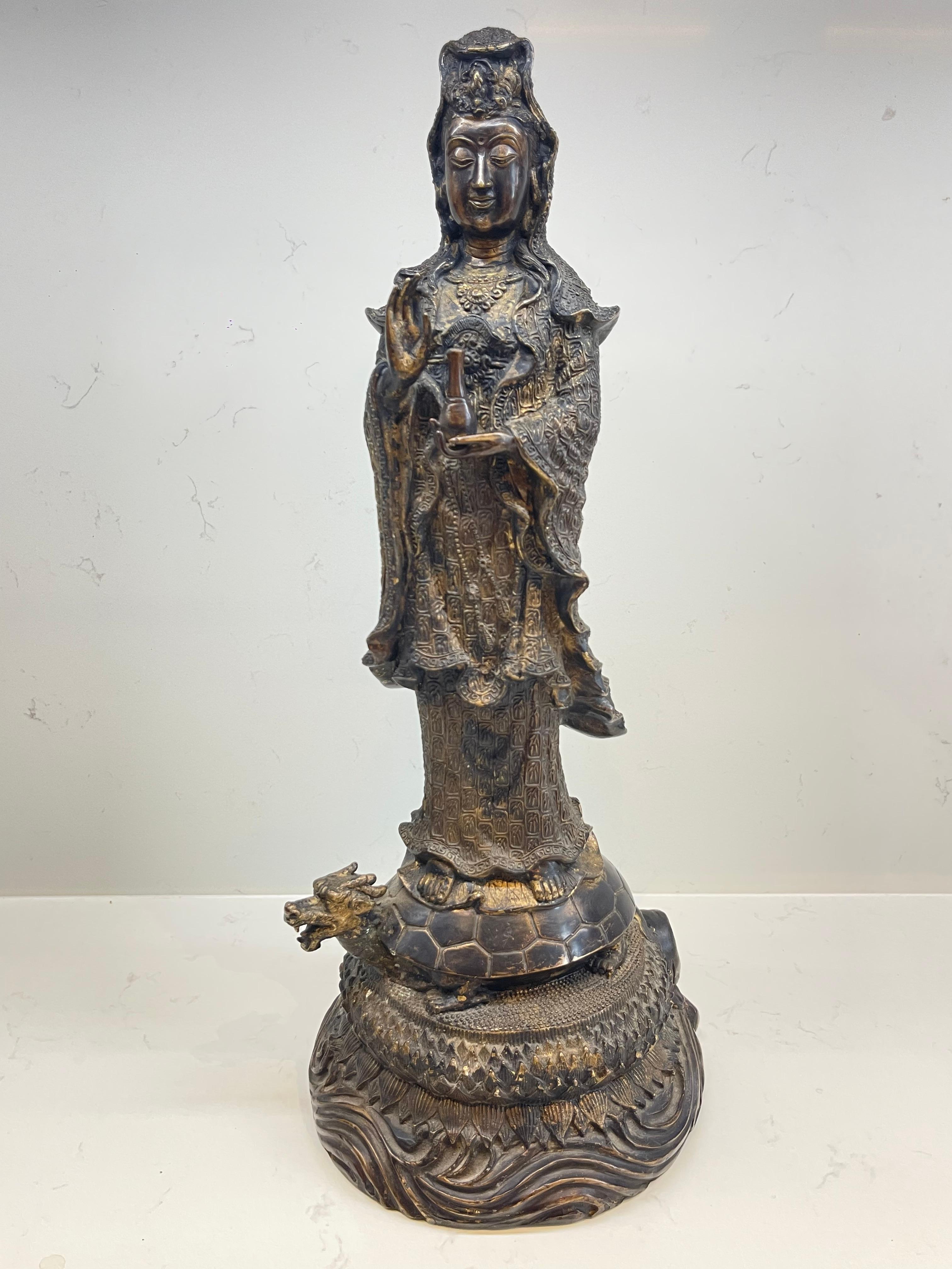 This large original bronze figure of Guanyin, depicting the bodhisattva with a sea dragon, is an exquisite example from the Qing dynasty, likely reflecting the intricate artistry and spiritual significance of the period. Guanyin, known as the