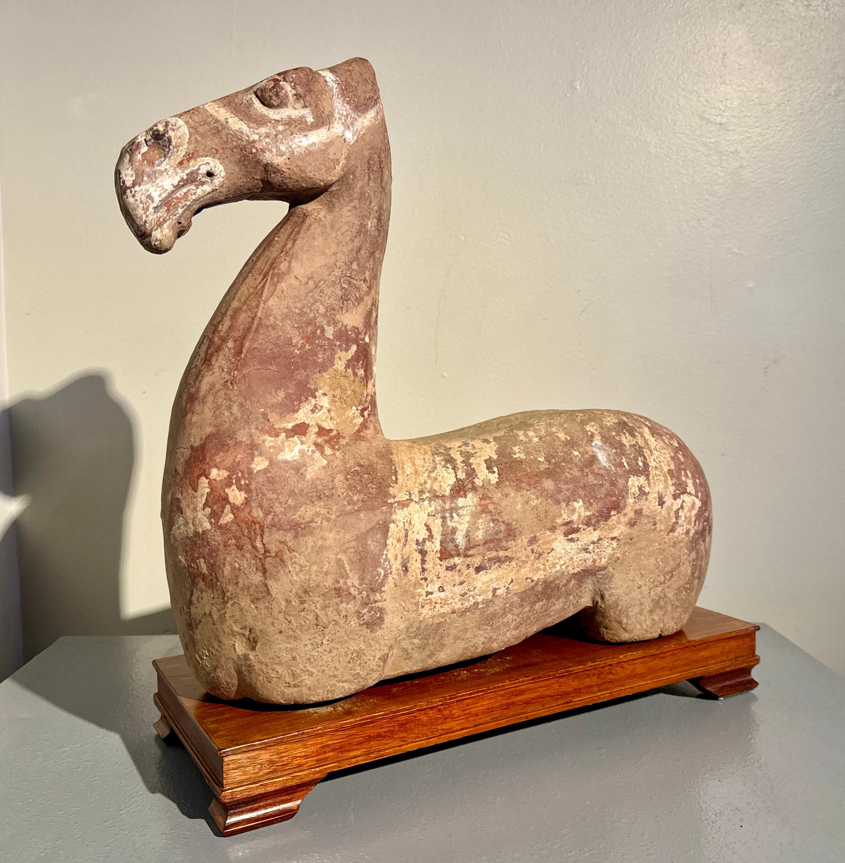 A large Chinese painted pottery figure of a horse torso, Han Dynasty (206 BC to 220 AD).

An unusually large Chinese Han Dynasty horse torso, also sometimes referred to as a recumbent horse, crafted from fired red pottery, with remnants of a slip