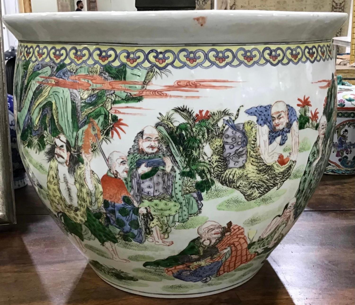 Large colorful vintage Chinese porcelain fishbowl. Features Classic, oriental scenes with Chinese people throughout. The ceramic bowl is painted on the inside as well with a traditional coy-fish illustration. The fishbowl could also be used as deep