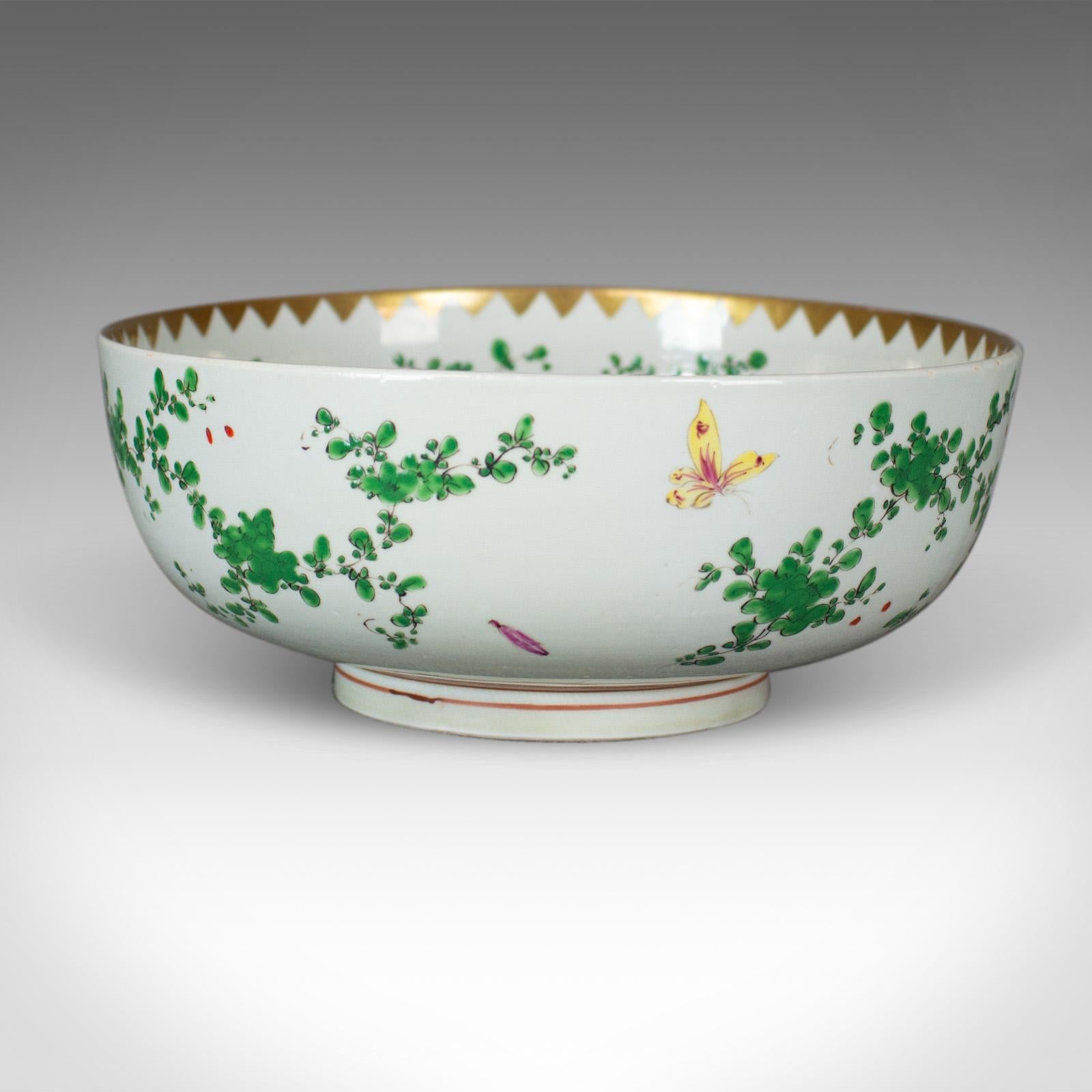 This is a large Chinese porcelain lychee bowl in natural tones on a white ground dating to the late 20th century.

An attractive bowl in good condition throughout
Painted with exotic birds, butterflies and foliage on a white ground
The inner rim