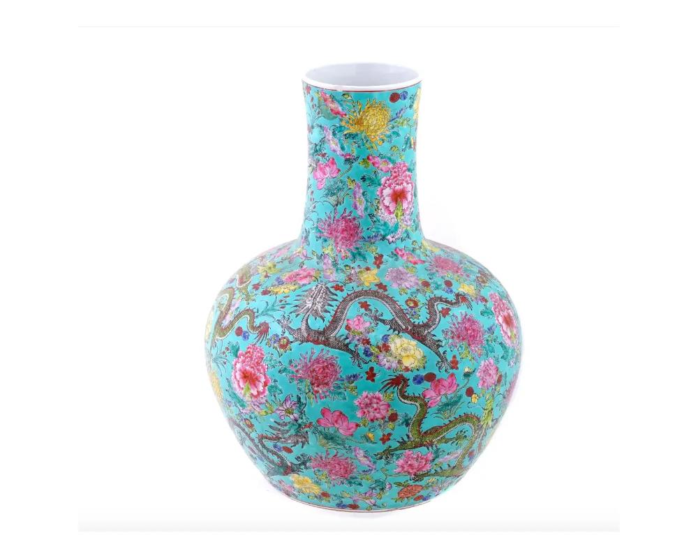 A beautiful porcelain antique vase richly decorated with flowers and colorful dragons. Bears a red ink Qianlong four character mark on the bottom. A fine example of Chinese porcelain. Chinese Porcelain appeared by the middle of the Zhou Dynasty,