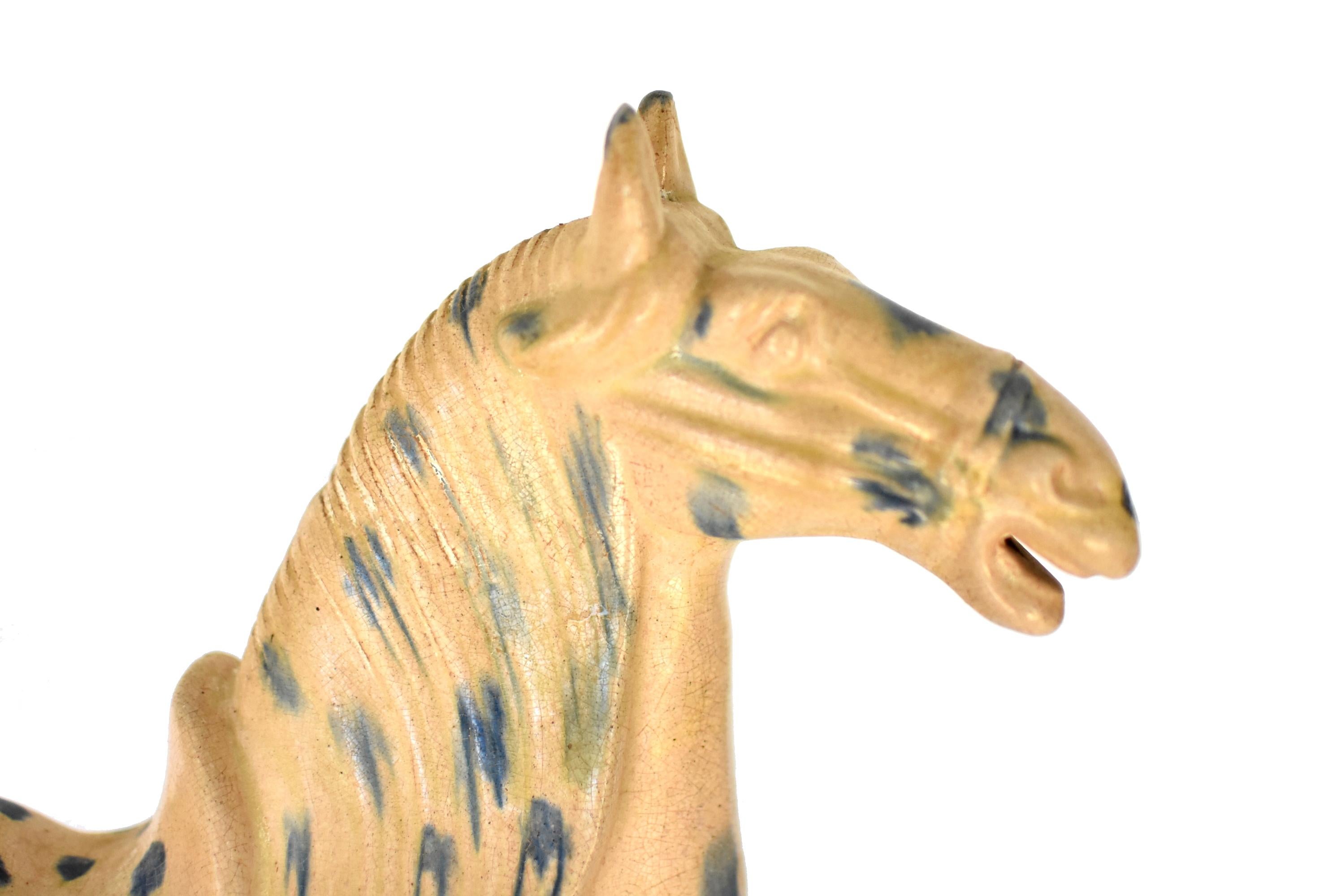 A majestic, large, white butterscotch San Cai horse in high gloss. The Sancai technique dates back to the Tang dynasty (618–907AD). This wonderful piece has all the hallmarks of Tang San Cai terracotta potteries with skillfully applied glaze