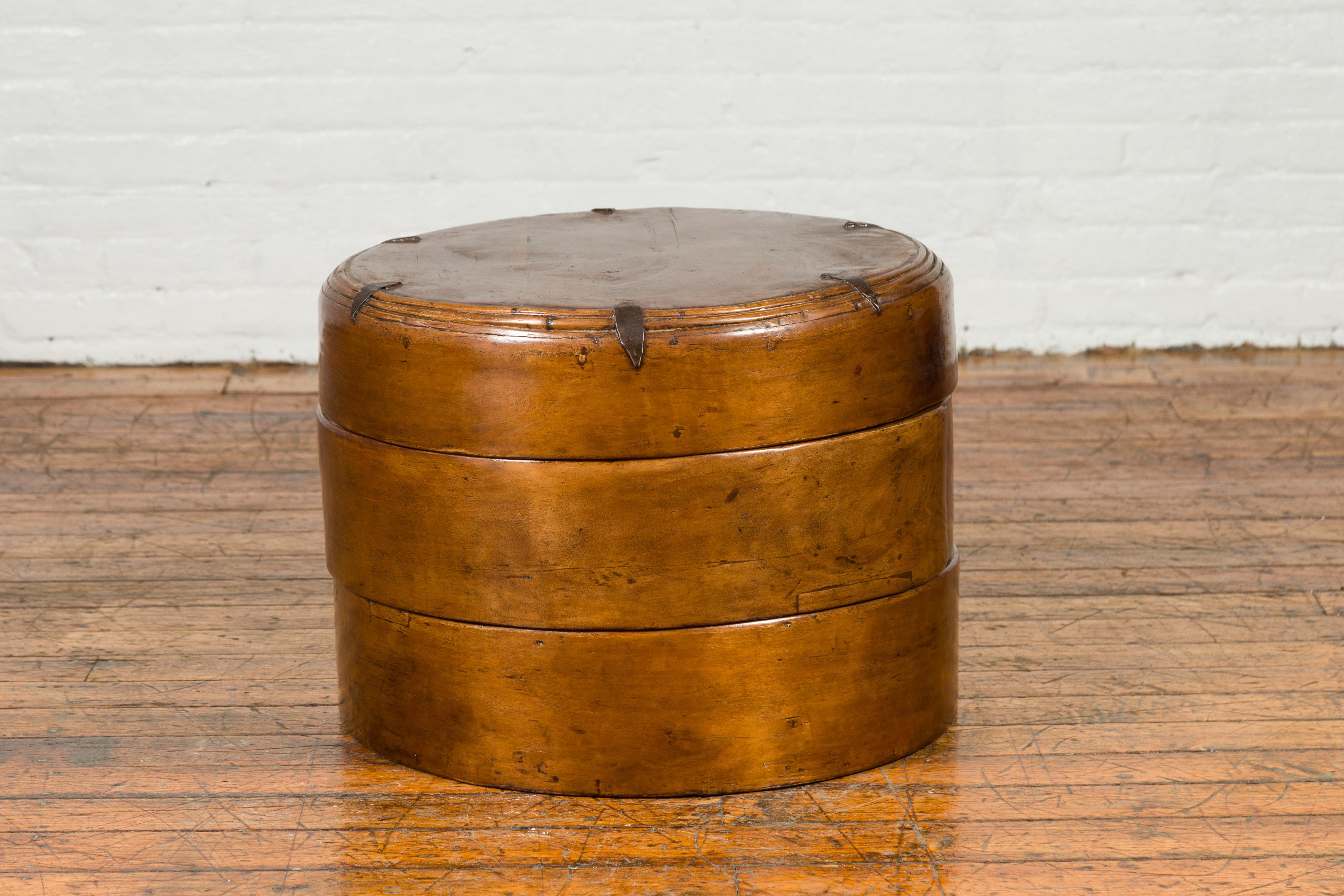 A large Chinese Qing Dynasty elmwood three-section round wooden picnic basket from the 19th century, used for storage or as a side table. Created in China during the Qing Dynasty, this large elmwood picnic basket is made of three independent