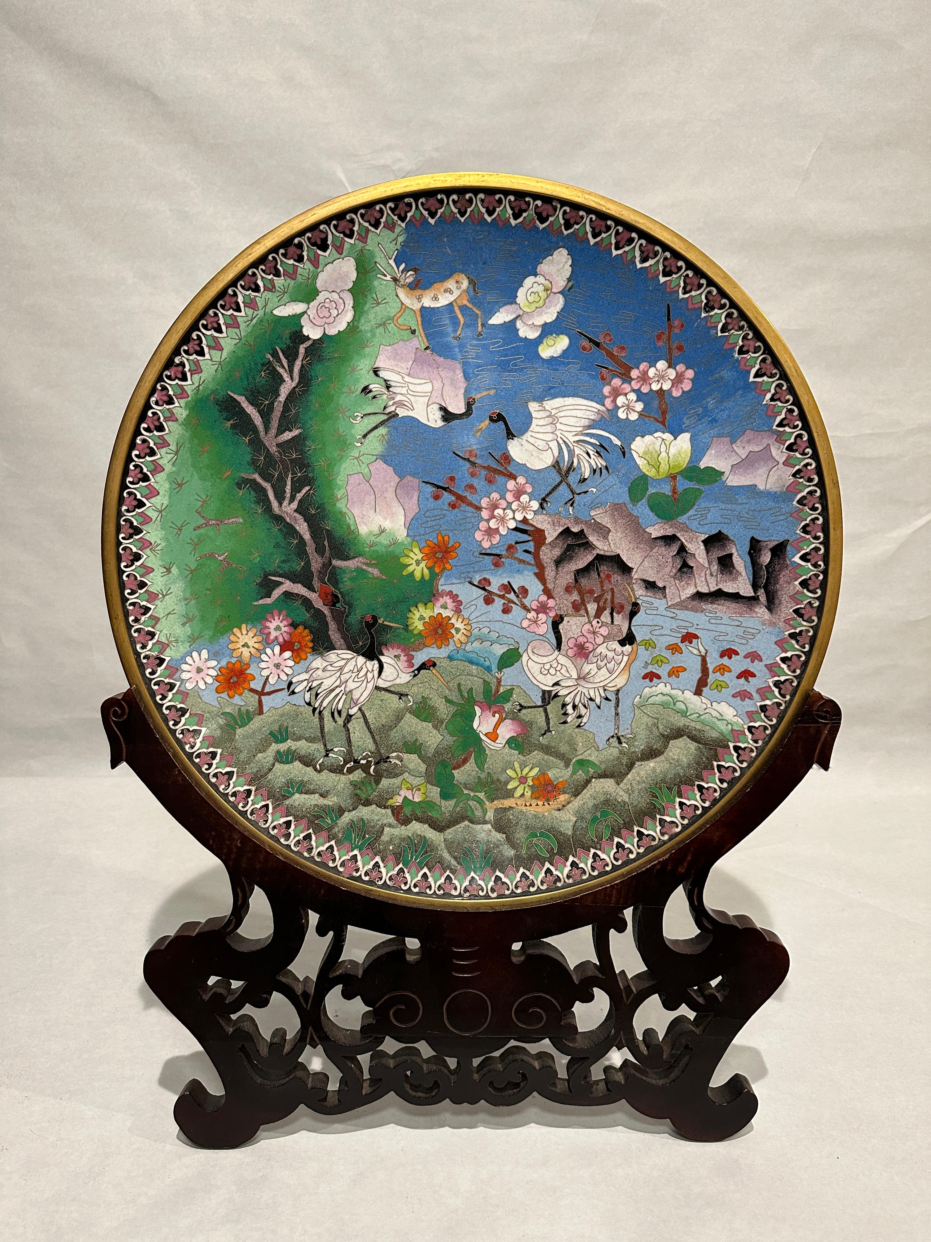 Large Chinese Qing Dynasty enamel bronze cloisonne charger. Unusual and rare bronze Chinese Qing Dynasty Cloisonne charger. The brightly multicolored enamel decoration features Crane birds and many colorful florals, trees, cherry blossoms and