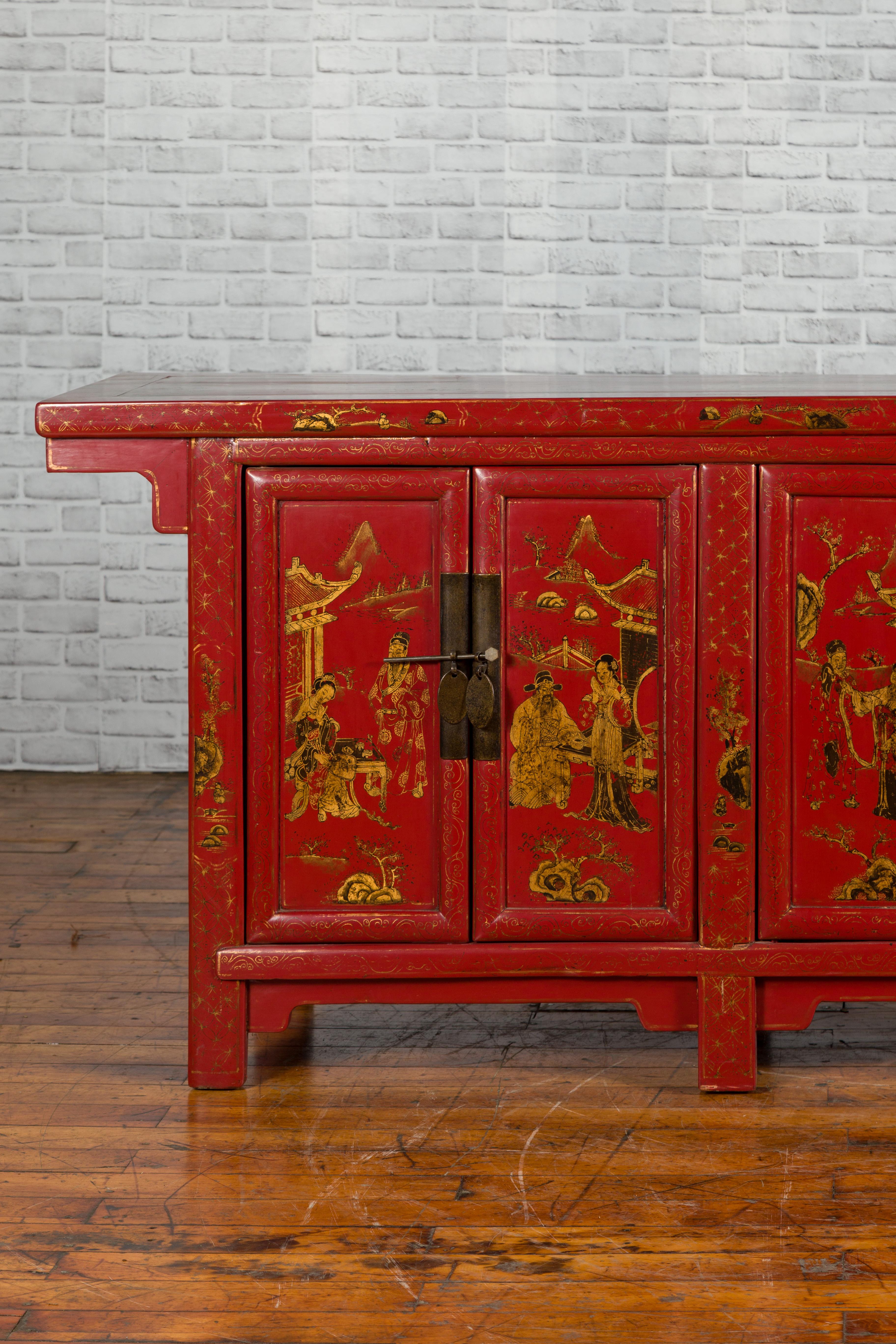 An antique North-Eastern Chinese red lacquered sideboard from Shanxi, with six doors and painted gold chinoiserie motifs. Created in Shanxi during the early years of the 20th century, this long, red lacquered sideboard features a rectangular top