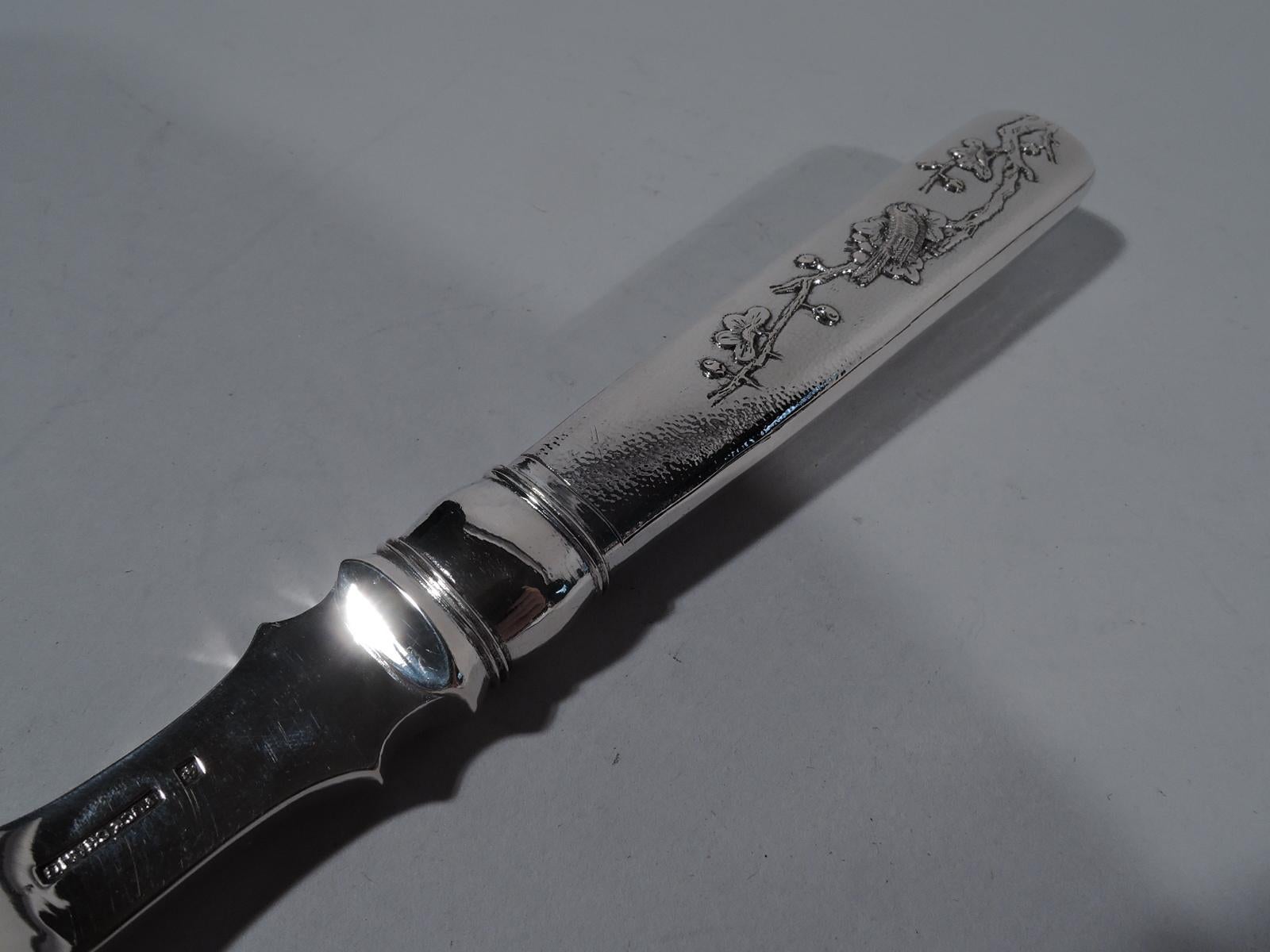 Turn-of-the-century Chinese export silver serving fork. Retailed by Tuck Chang in Shanghai. Scalloped 4-tine shank engraved with fish and grass. Handle tapering and hollow. Double-sided ornament with birds perched on blossoming prunus branches.