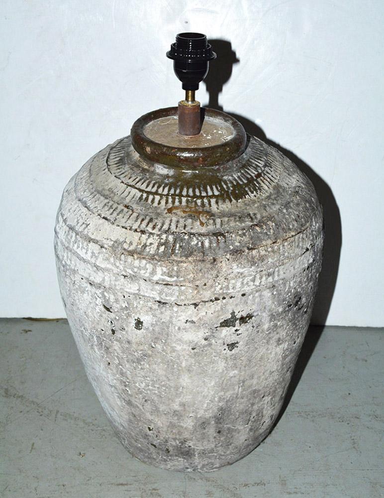 The large white painted/grey green lamp base is a rustic vintage Chinese clay jar used for wine storage. En relief bands circle the top of the jar. The lamp is wired for US electrical use. Bulb socket is euro type so will require euro shade or