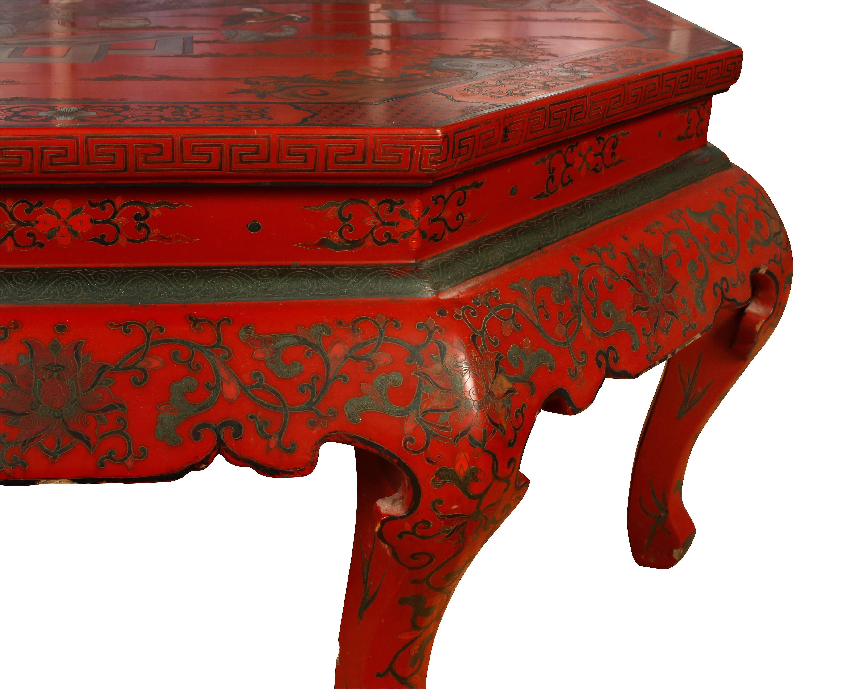 Large Chinese style octagonal red lacquer scenic coffee table.