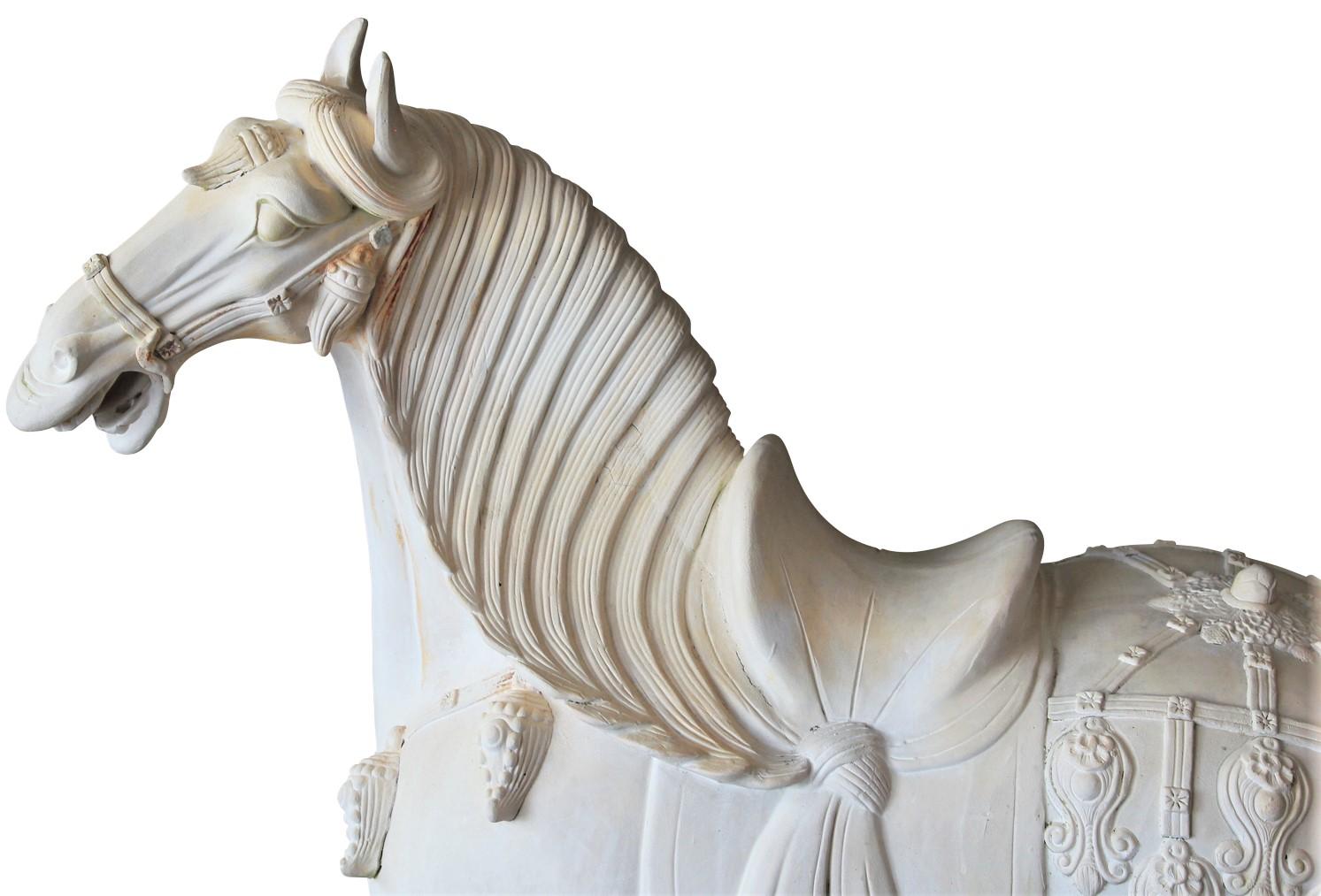 Early ceramic reproduction of a Tang Dynasty horse sculpture. During the Tang Dynasty, horses were a precious import and therefore became an emblem of wealth and power. Because of this, they were a common motif in tomb figures. This piece features a