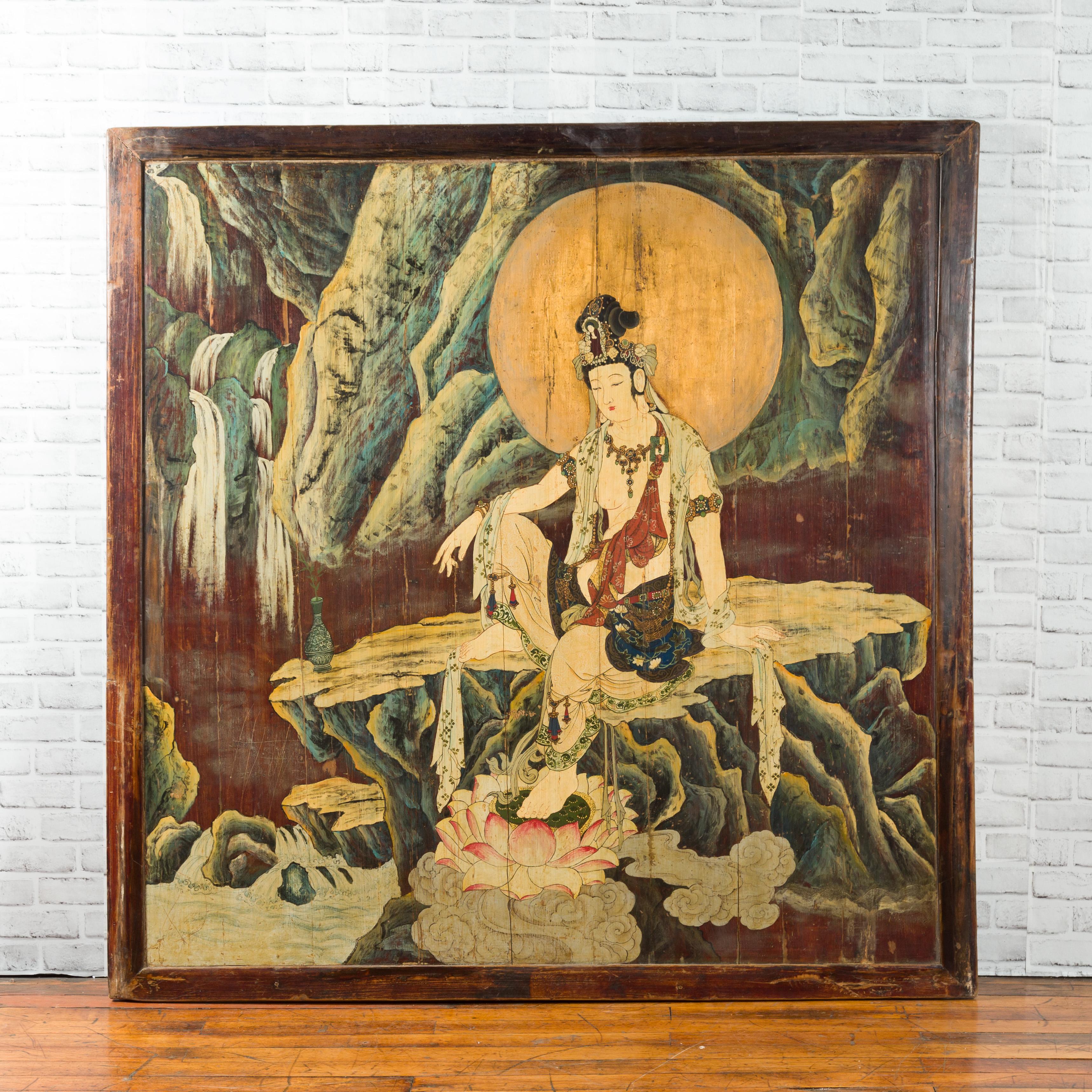 An antique Chinese unusual large hand painted two-sided elm divider depicting Guanyin and Zhong Kui, from the first half of the 20th century. Handcrafted in China, this large rectangular elmwood screen divider is painted with numerous colors on a
