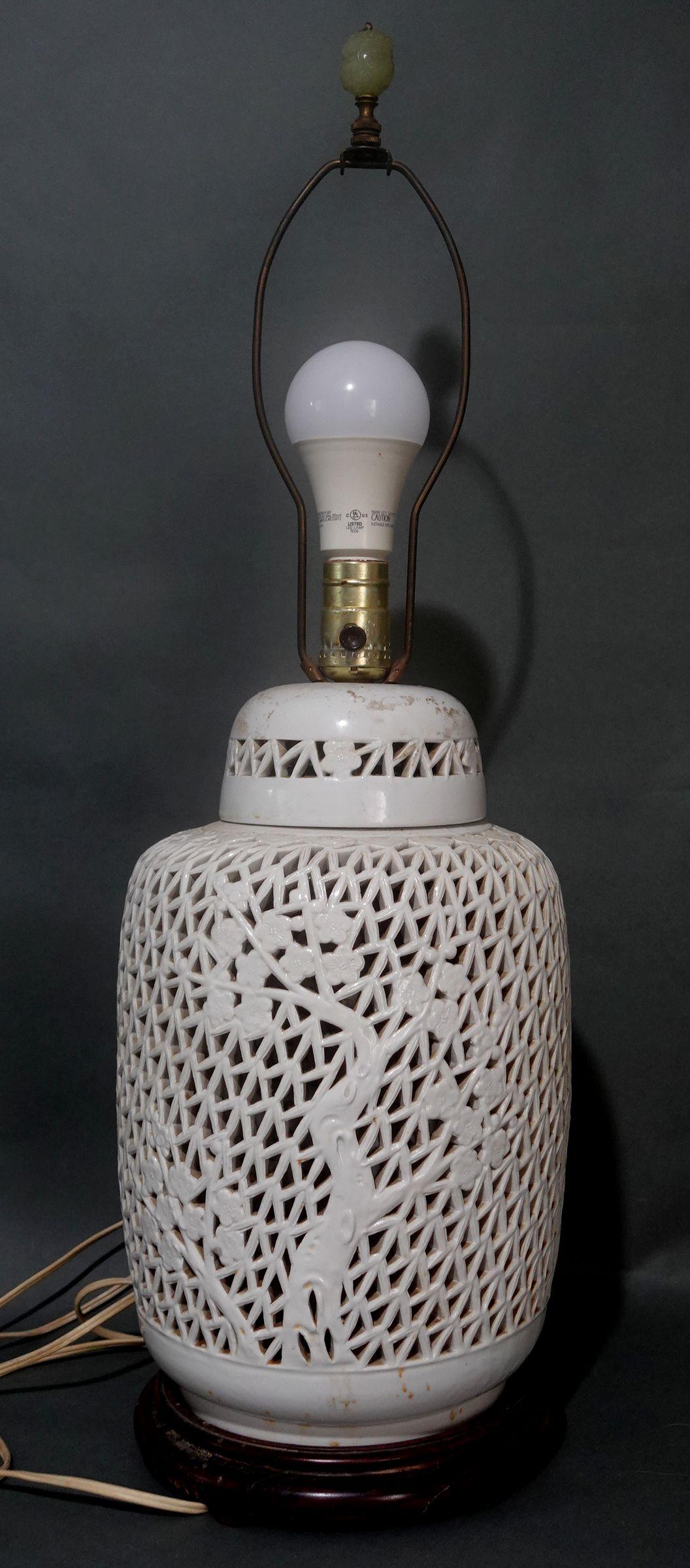 Beautiful reticulated white porcelain lamp with foliate scroll background and flowers in low relief on the body of the lamp.
The finale is a carved jade. The vase is in excellent condition, with no damage and no repairs, just some dust on it.
- It's