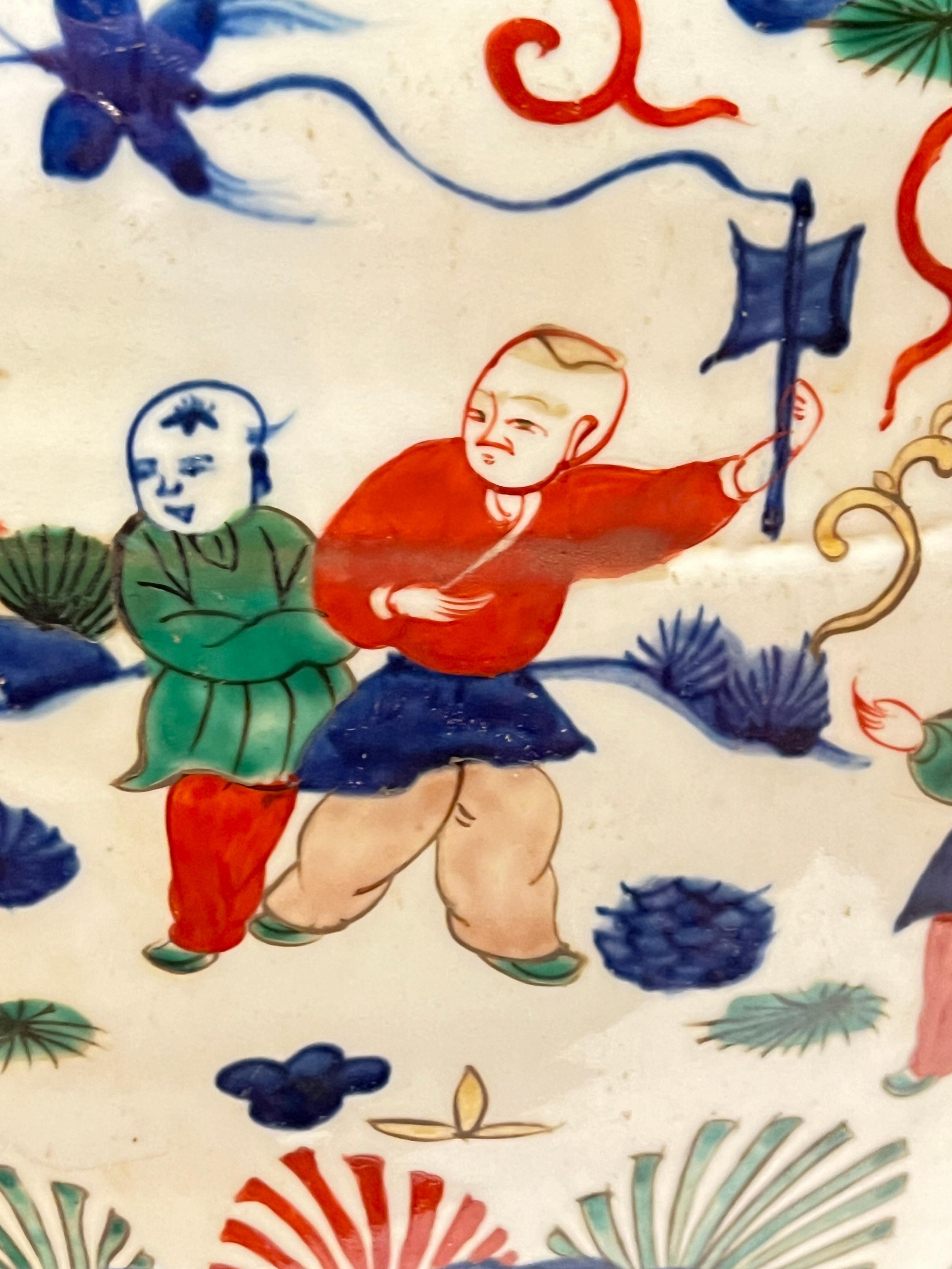 Very large Wucai porcelain jardiniere with scenes of courtiers and children at play in a garden.  Signed with the mark of the Jiajing emperor of the Ming dynasty.  
