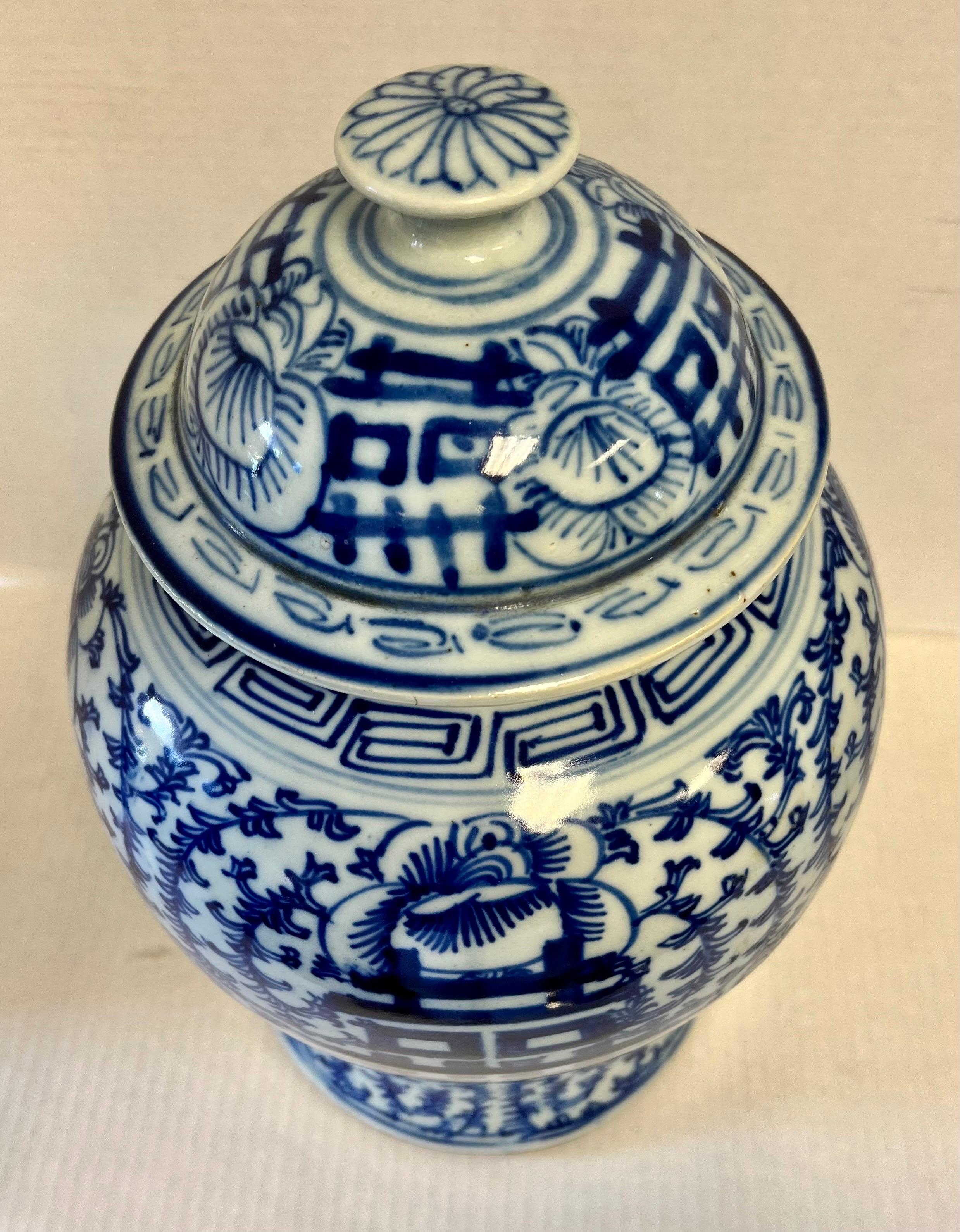 Large Chinese porcelain vase with hand-painted decoration in cobalt blue. The body of the vase is covered with floral designs and geometric decorations. At the center of the vase is an important ideogram, a sort of wish for luck, happiness, and