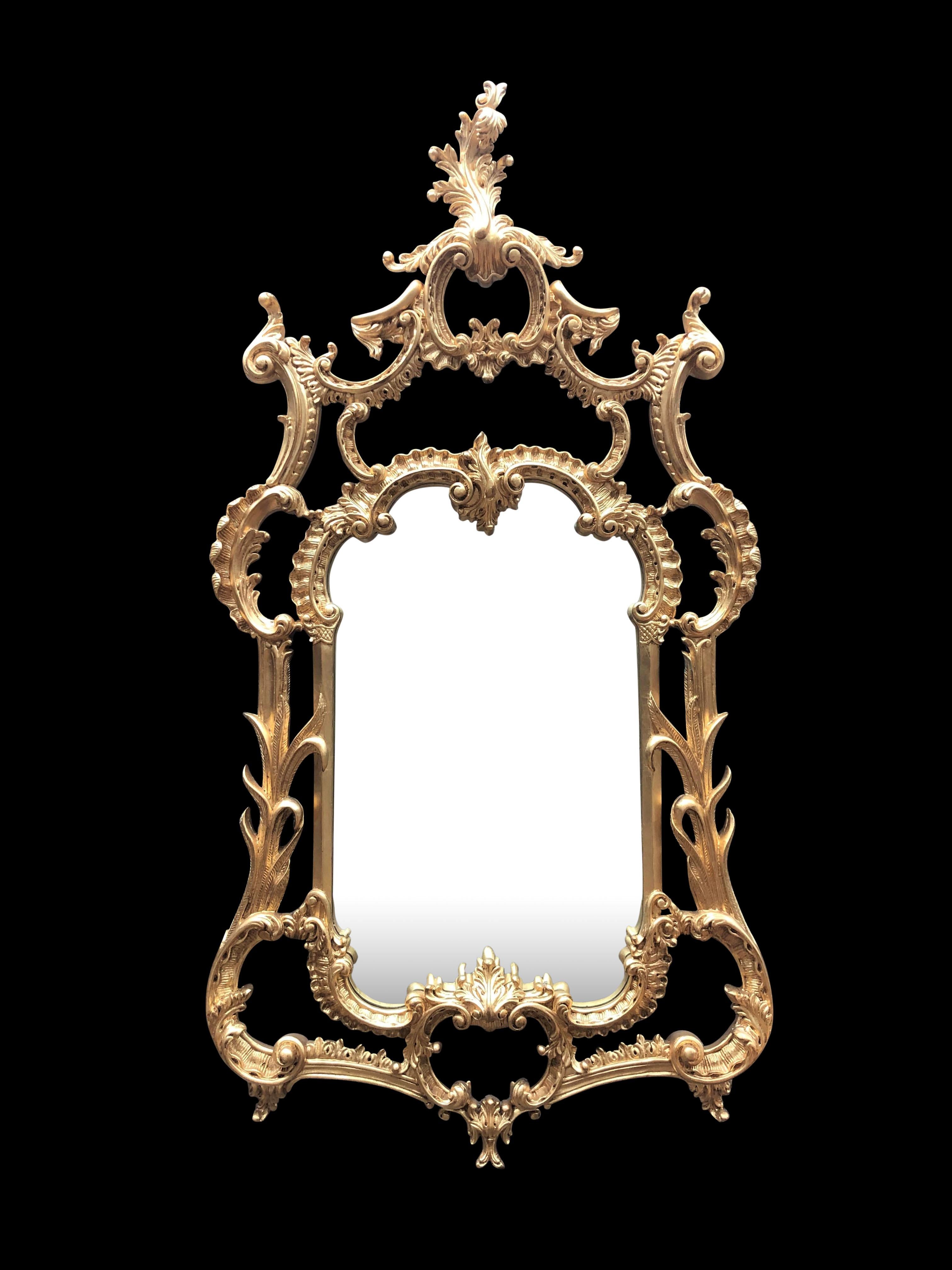 A large and gorgeous Chippendale gilt pier mirror with Rococo Flourishes, carved wood, 20th century. Stunning piece at over four feet tall so good size. Definitely ready to steal attention in any interior. Very ornate frame with leaf motifs and