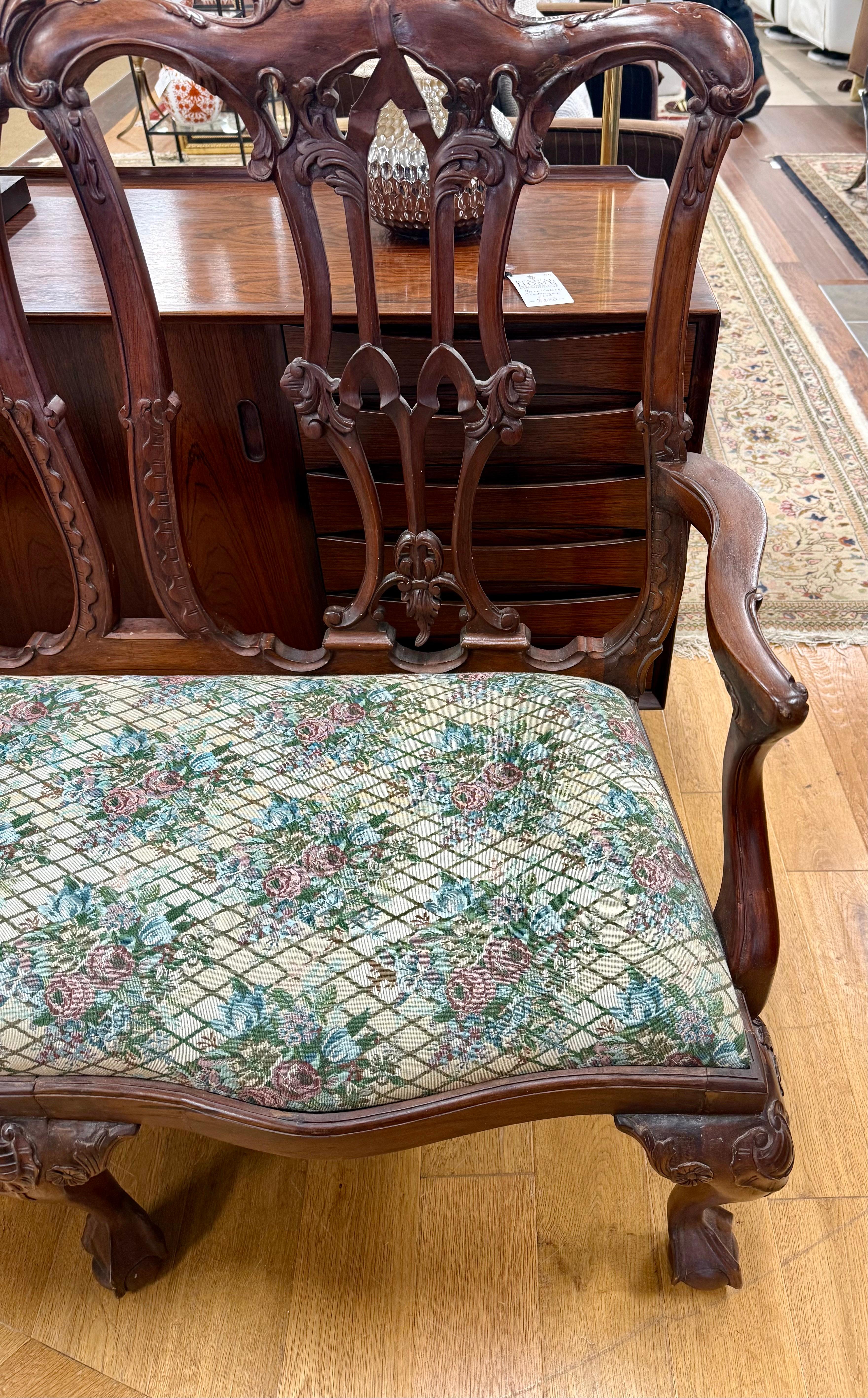 Stunning hand carved Chippendale six foot settee with gorgeous upholstery that is in mint condition.  The large settee sits great and features ball and claw feet as shown.