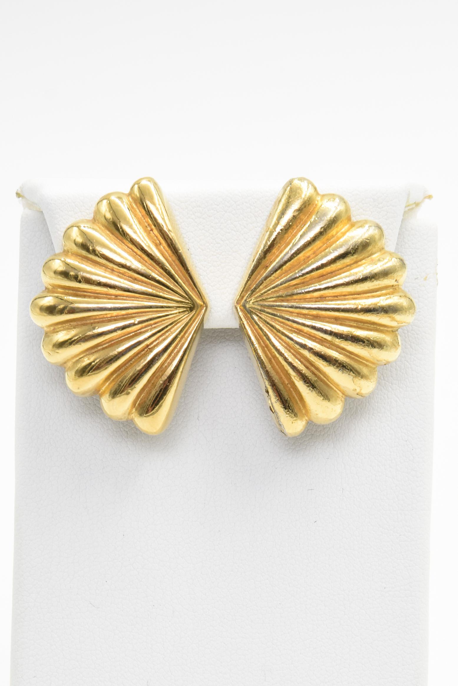 Stunning vintage clip on earrings by Christian Dior are gold-tone in the shape of a fan or shell. 
Clip on back so your ears don't need to be pierced.
Marked Chris. Dior 
