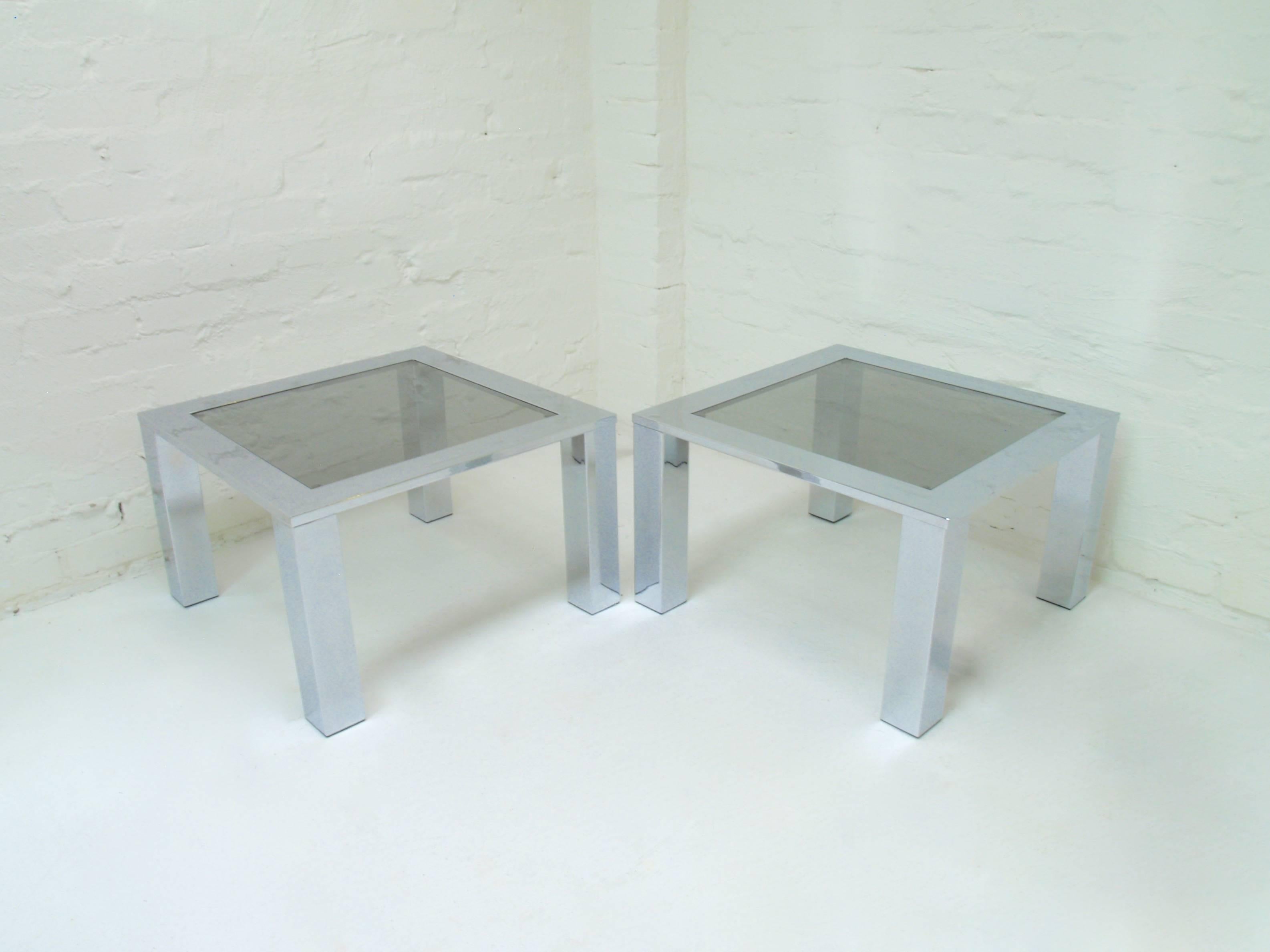 Two available. Price per item. 

Belgo chrome and smoke glass tables dating from the late 1970s. We love their beautifully balanced proportions which show great care in their design and construction. 

These tables came from a magnificent home built
