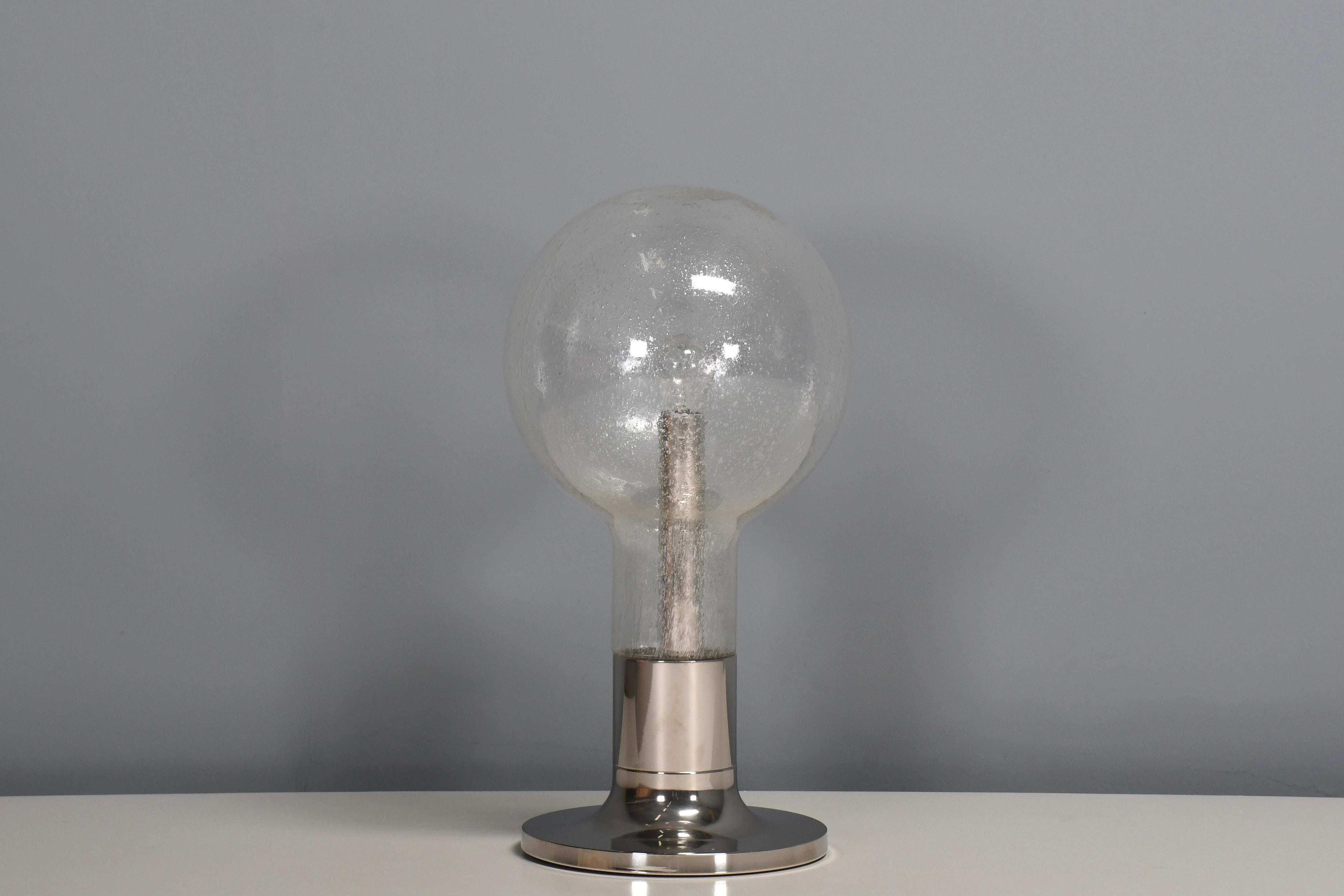 Large Chrome and Glass Table Lamp Temde Switzerland, 1970s 

Impressive table/floor lamp in very good condition.

Manufactured by Temde in the 1970s 

This lamp has a heavy chrome plated metal base which holds the glass and the socket inside the