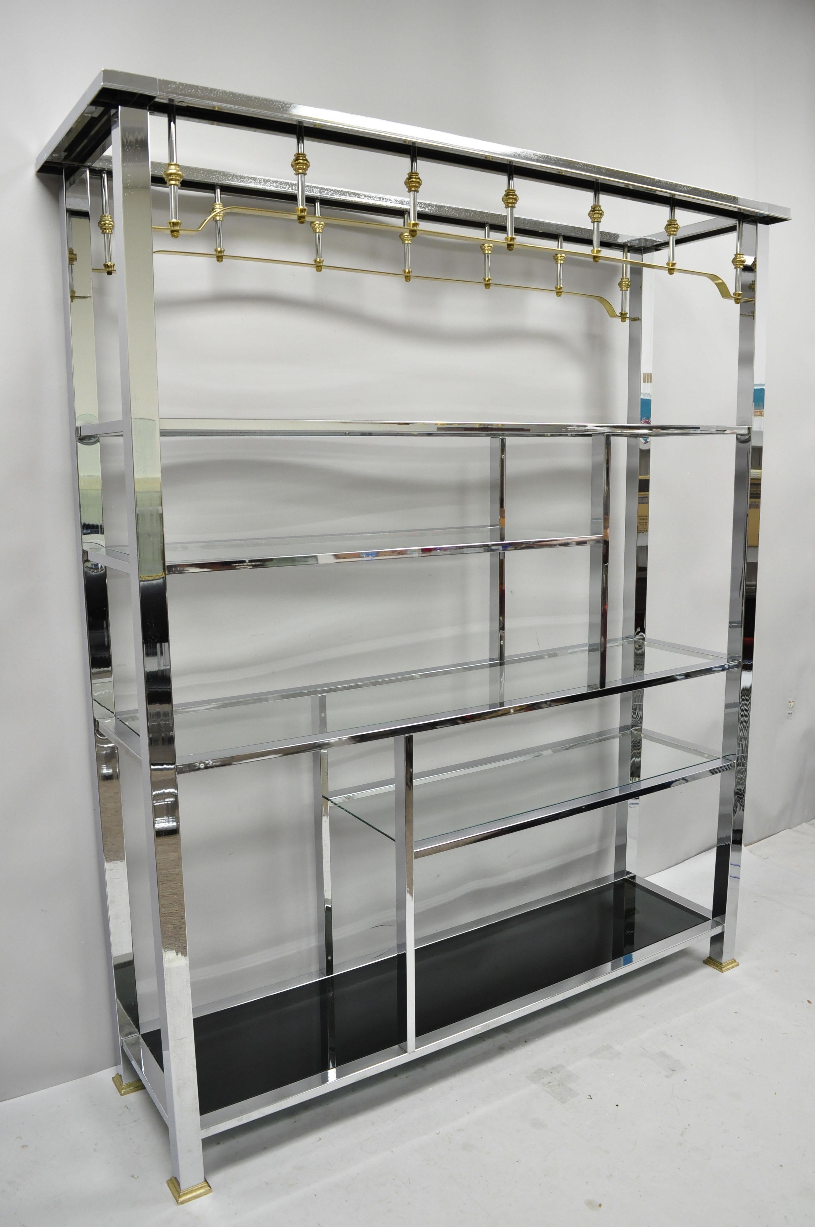 Large vintage chrome and brass Hollywood Regency Mid-Century Modern étagère display shelf. Item features a large impressive size, various shelf length and height, brass accents, 5 glass shelves, smoked glass lower shelf, very nice vintage item,
