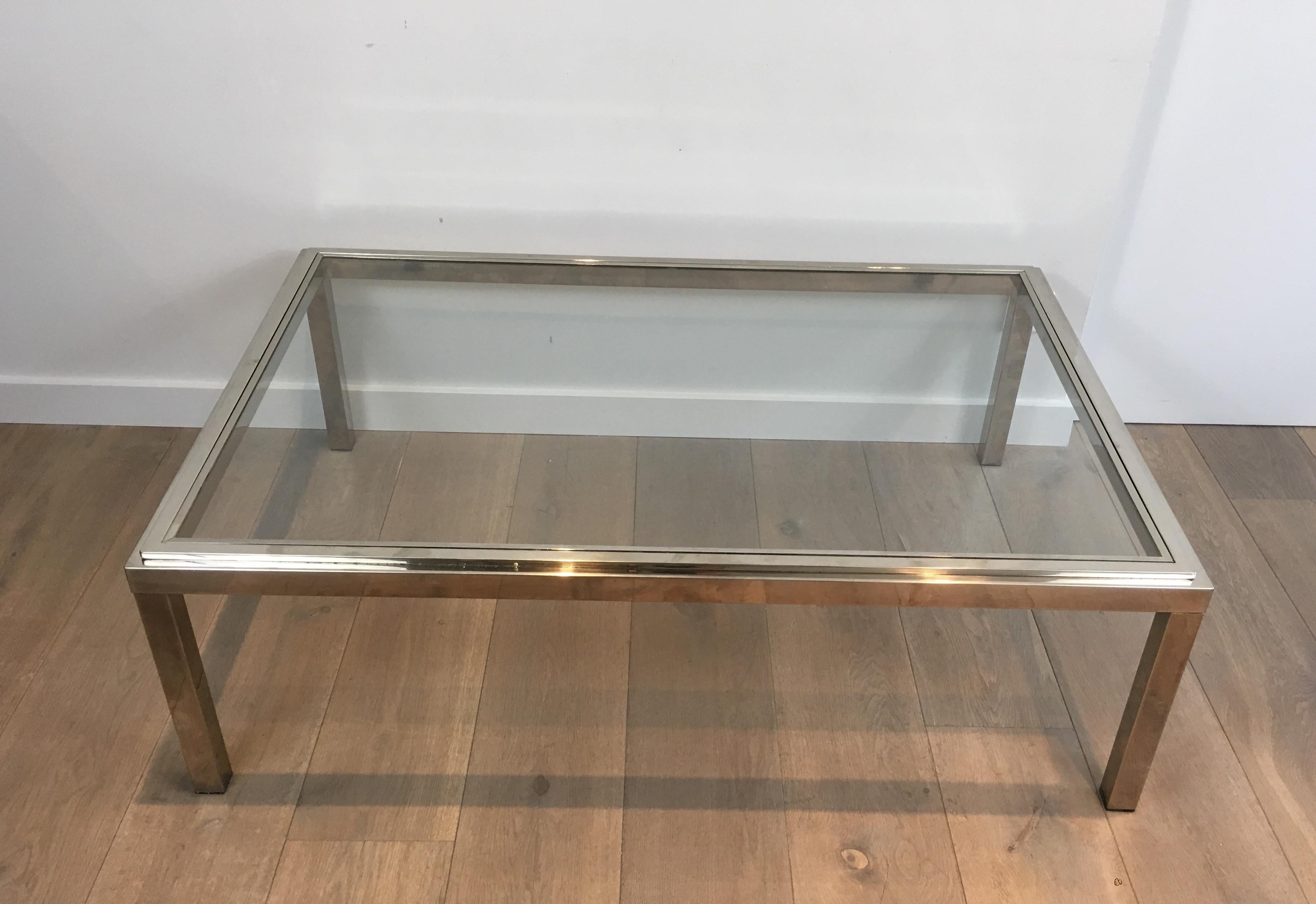 Large chrome coffee table with clear glass shelf, French, circa 1970.