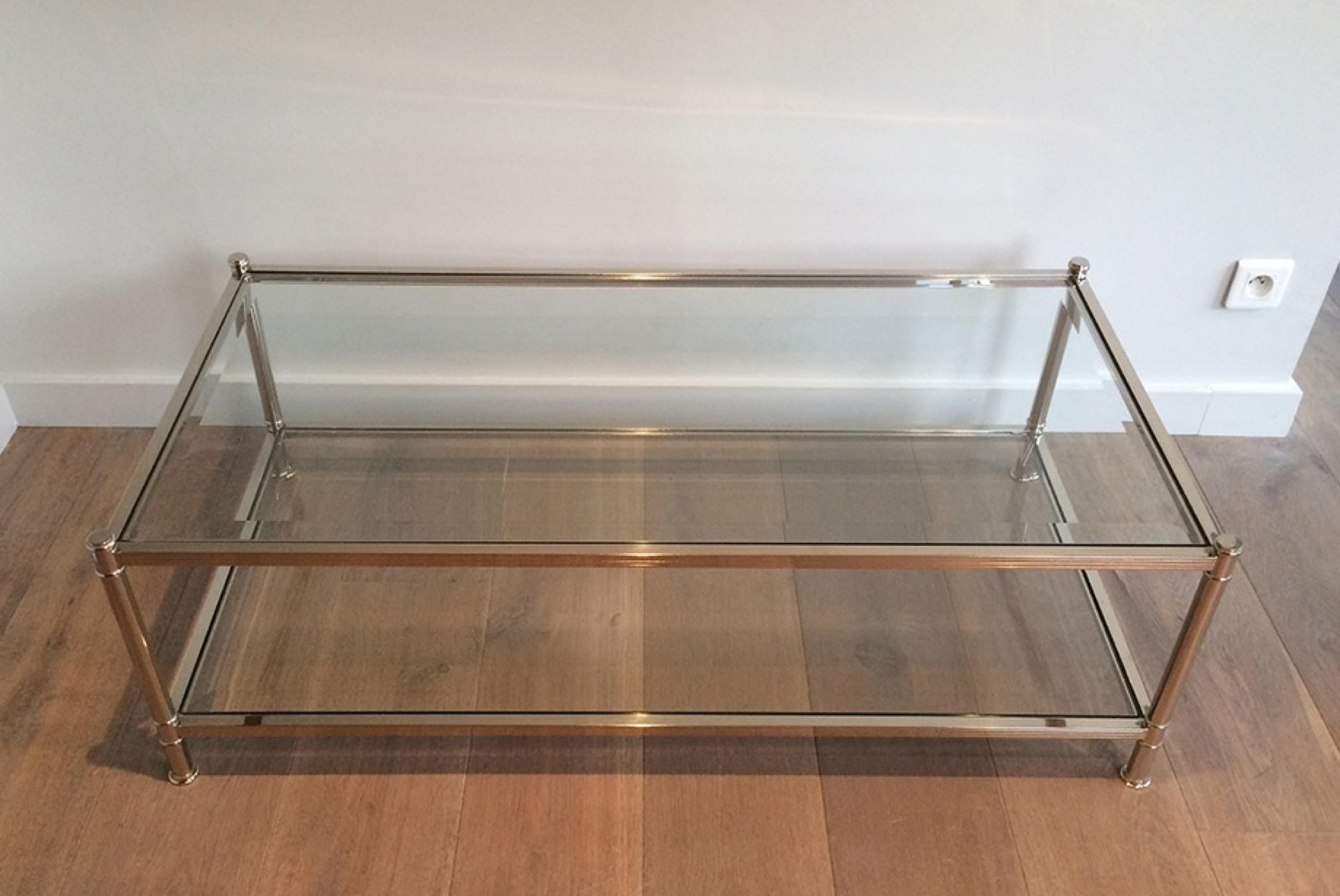 This large coffee table is made of chrome with 2 glass shelves. This is a French design, very elegant, circa 1970.