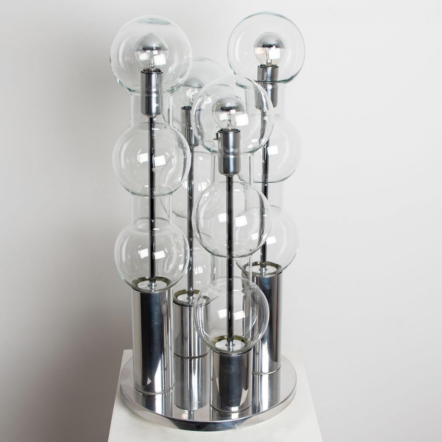 Four Doria hand blown glass bubbled tubes on a chrome base. Manufactured by Doria Leuchten Germany, circa 1970. This exceptional artefact of modern design reflects the extreme interest in modernism across Europe during this period. This unique lamp