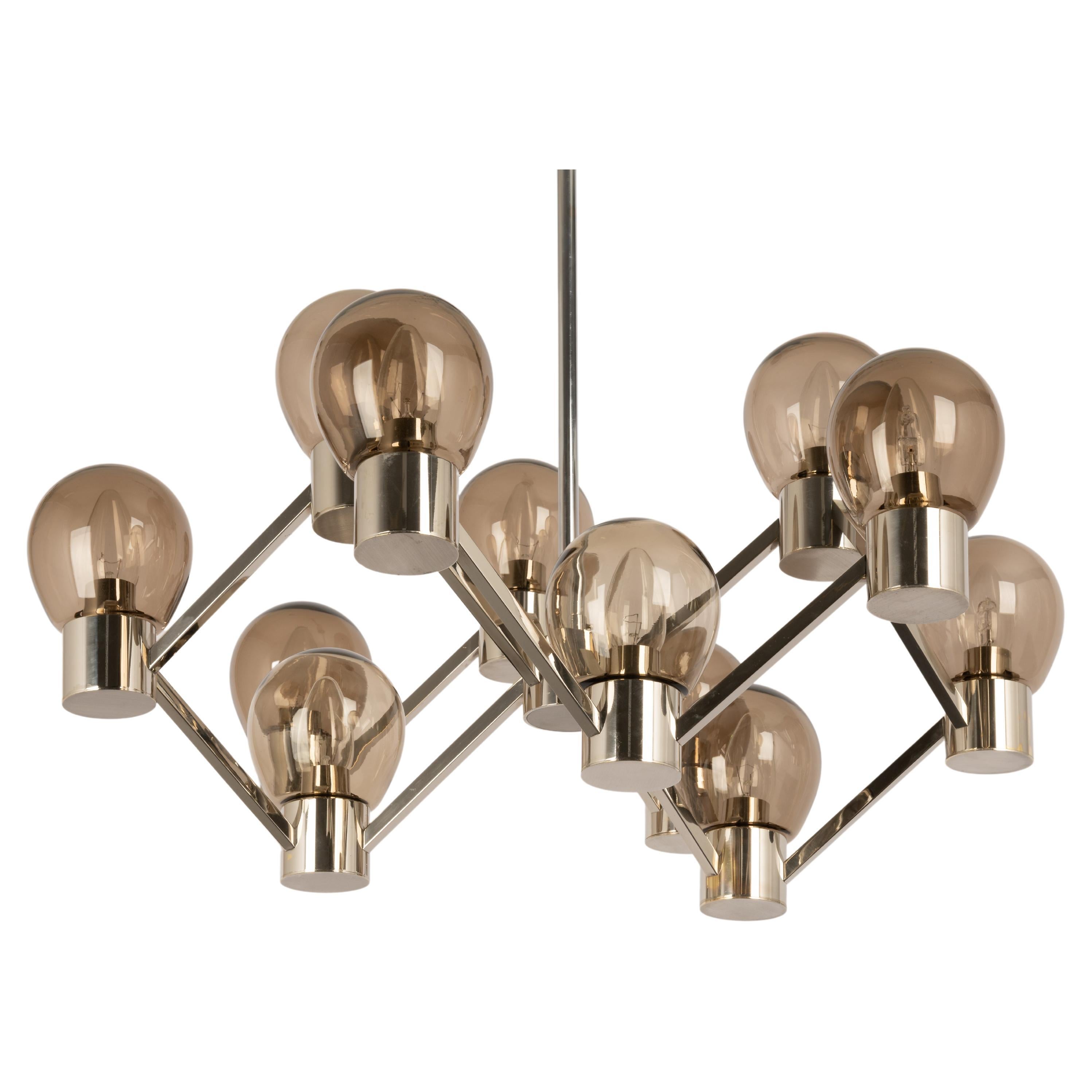 12-light Chrome chandelier in the style of Sciolari with smoked glasses.
Good quality and in good condition. Cleaned, well-wired, and ready to use. Small signs of age and use.

The fixture requires 12 x E14 Standard bulbs with 40W max each.
