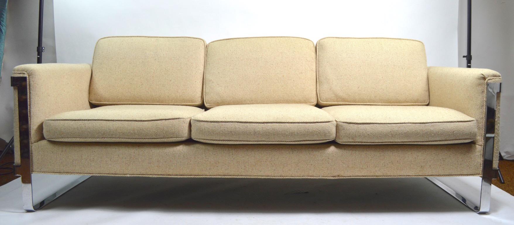 Sexy and sophisticated sofa, design attributed to Milo Baughman. Large scale, well crafted with top quality materials, and fine craftsmanship. Solid, and sturdy, upholstery shows some wear, and discoloration. Please view the companion barrel lounge
